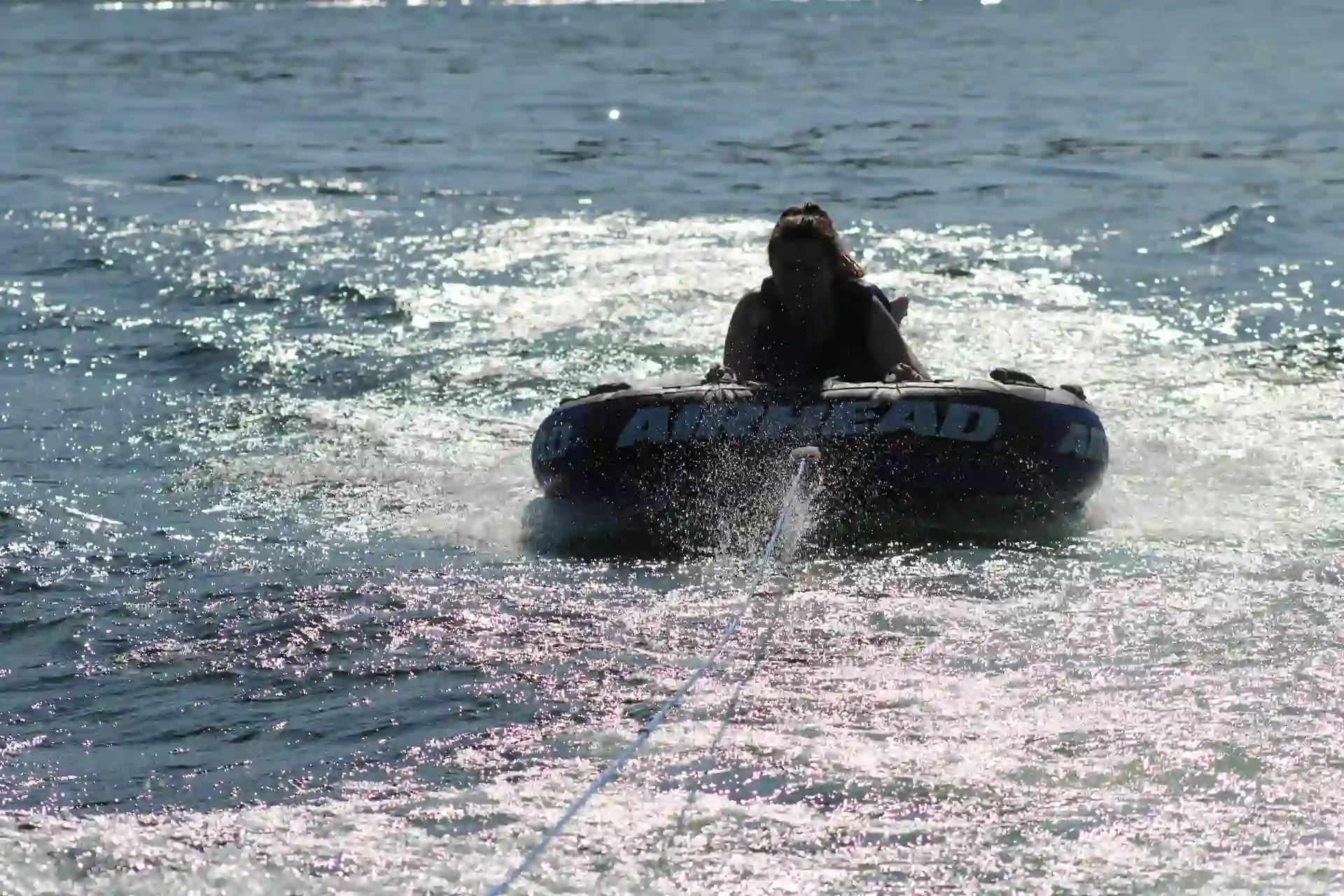 Silhouette of a woman tubing