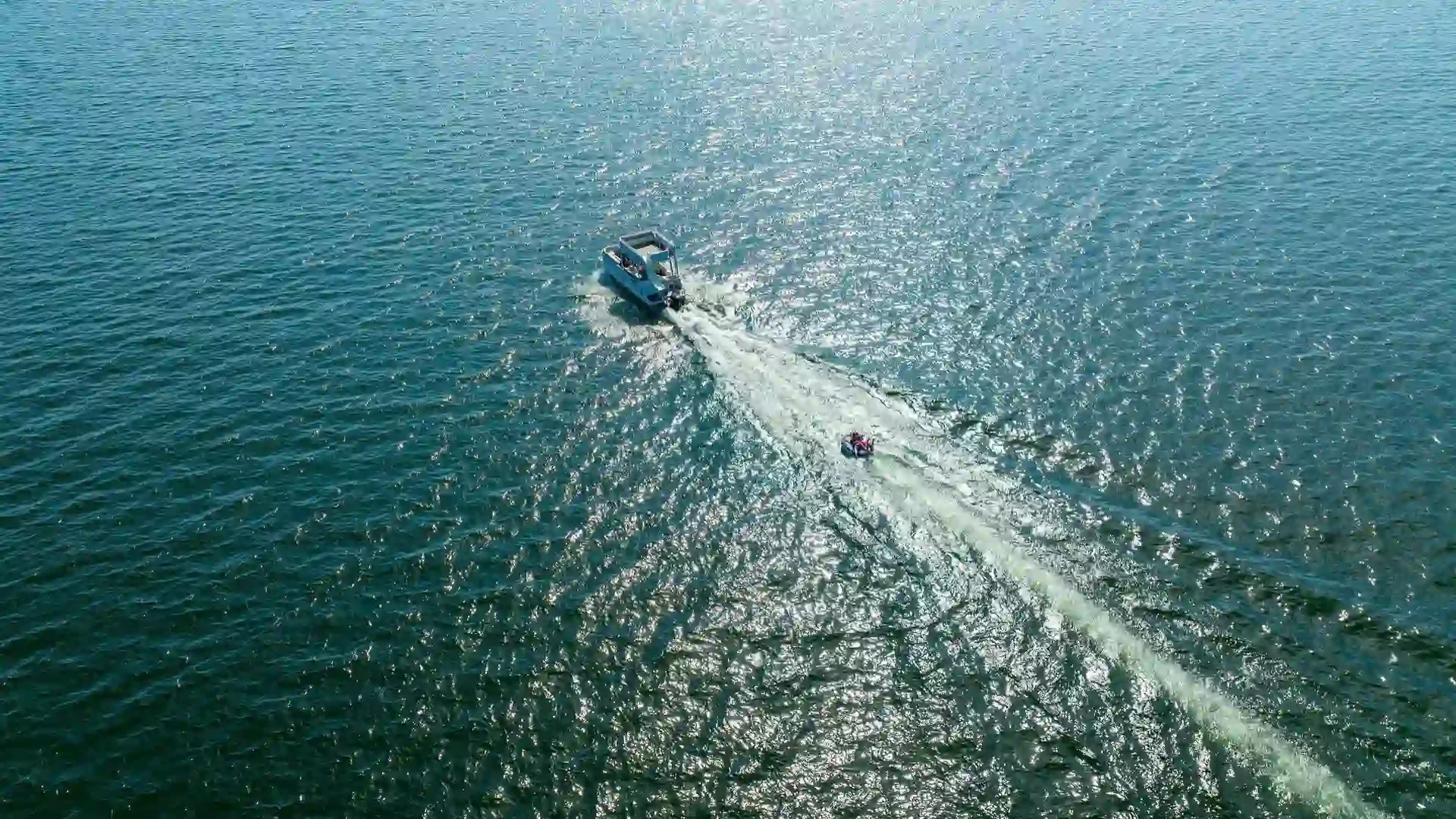 A Funship towing a tube on a lake