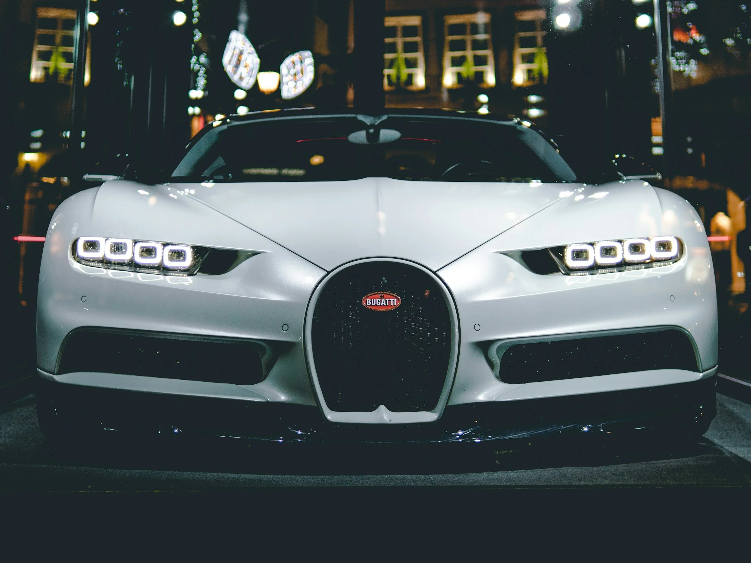 front of white car parked 8 headlight bugatti