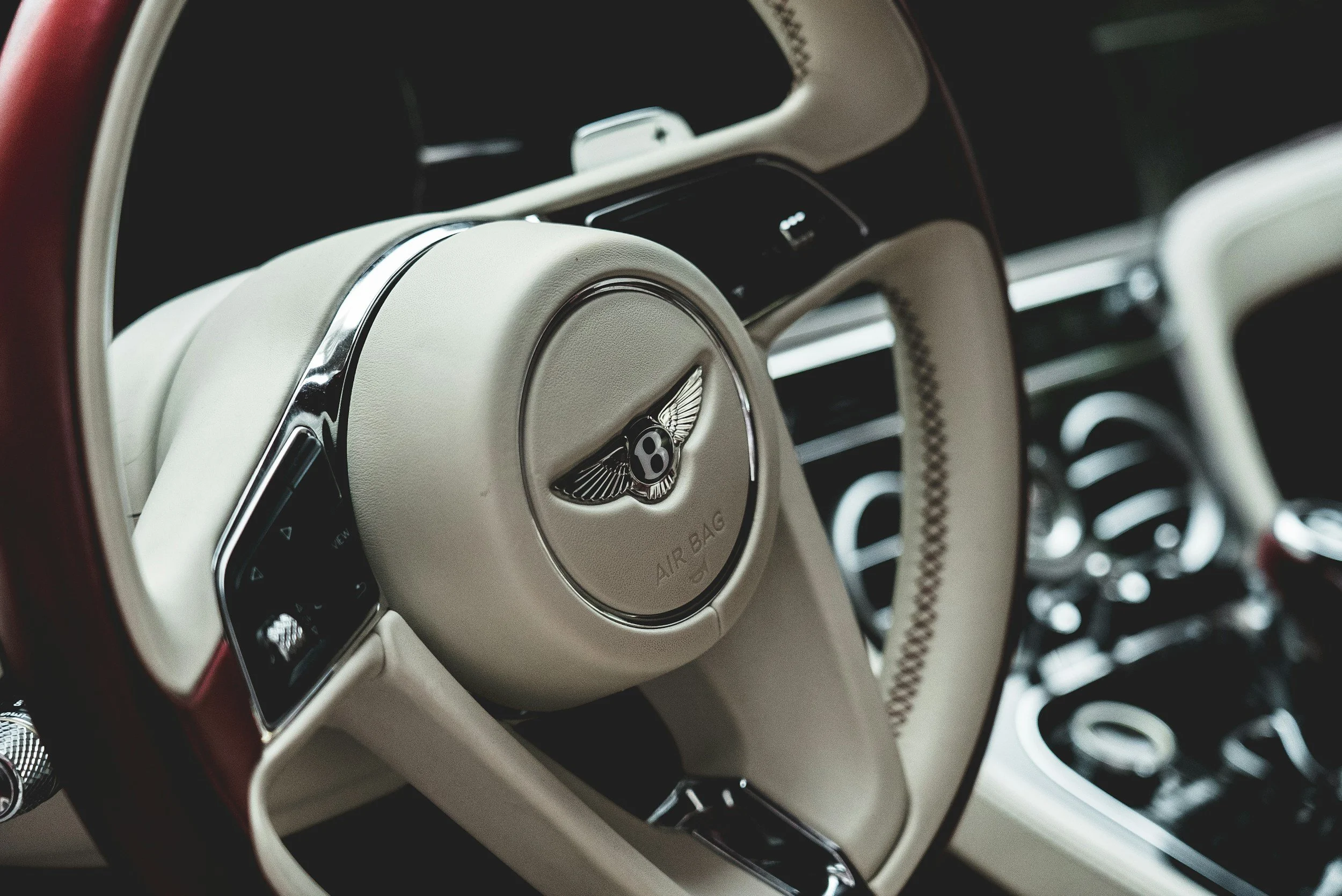 interior of a car bentley white red leather