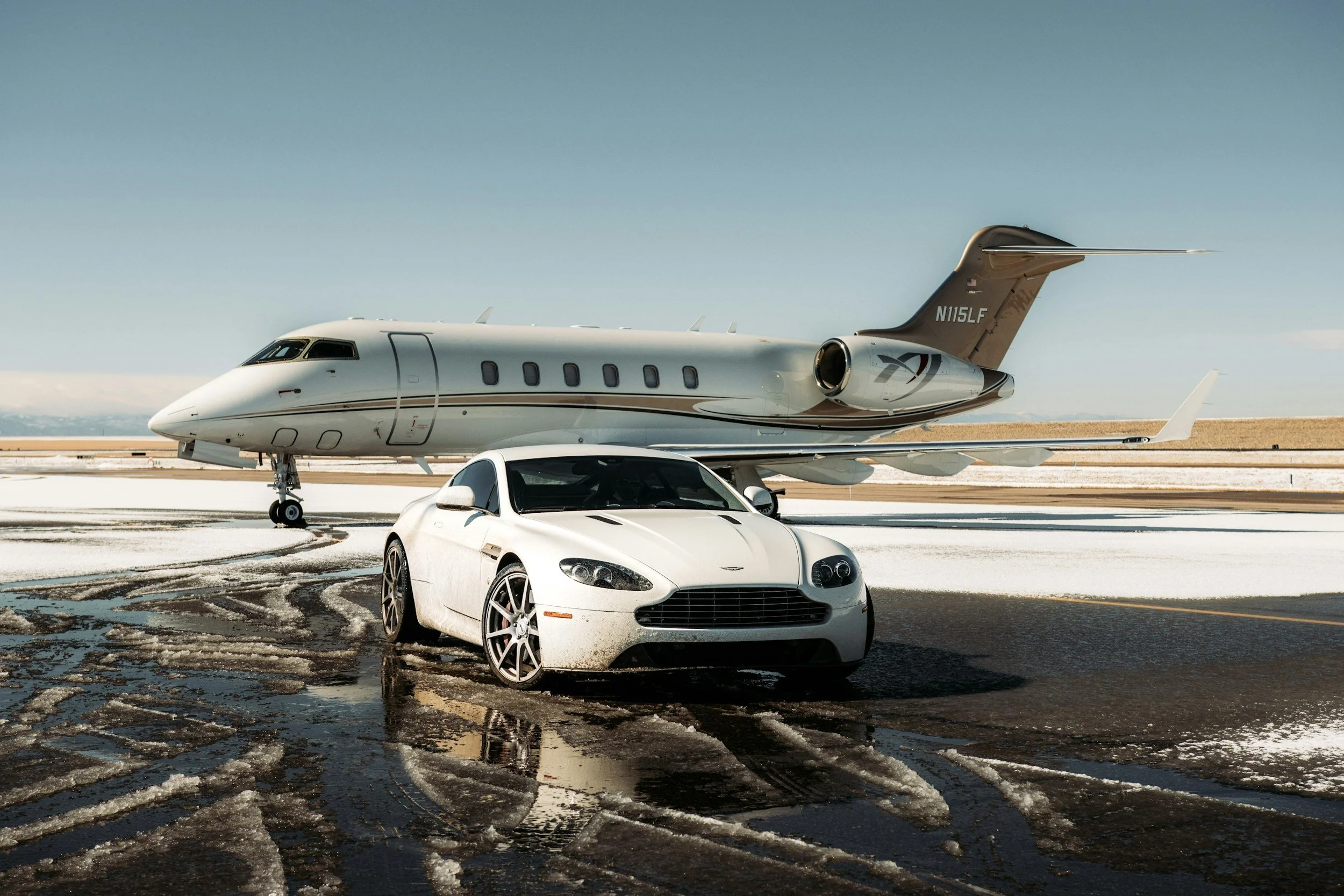 white car, white plane, car high end , snow on ground