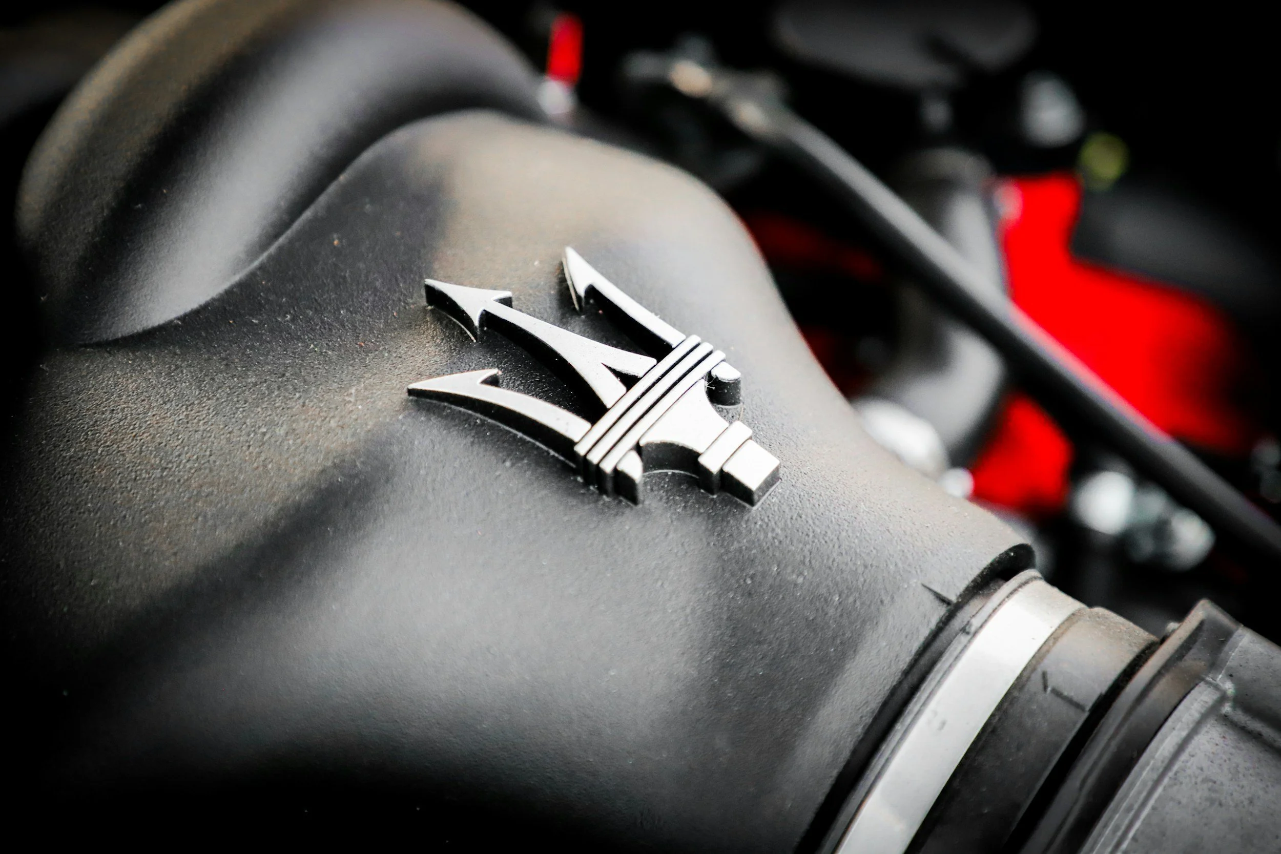 car engine with black red and silver car emblem