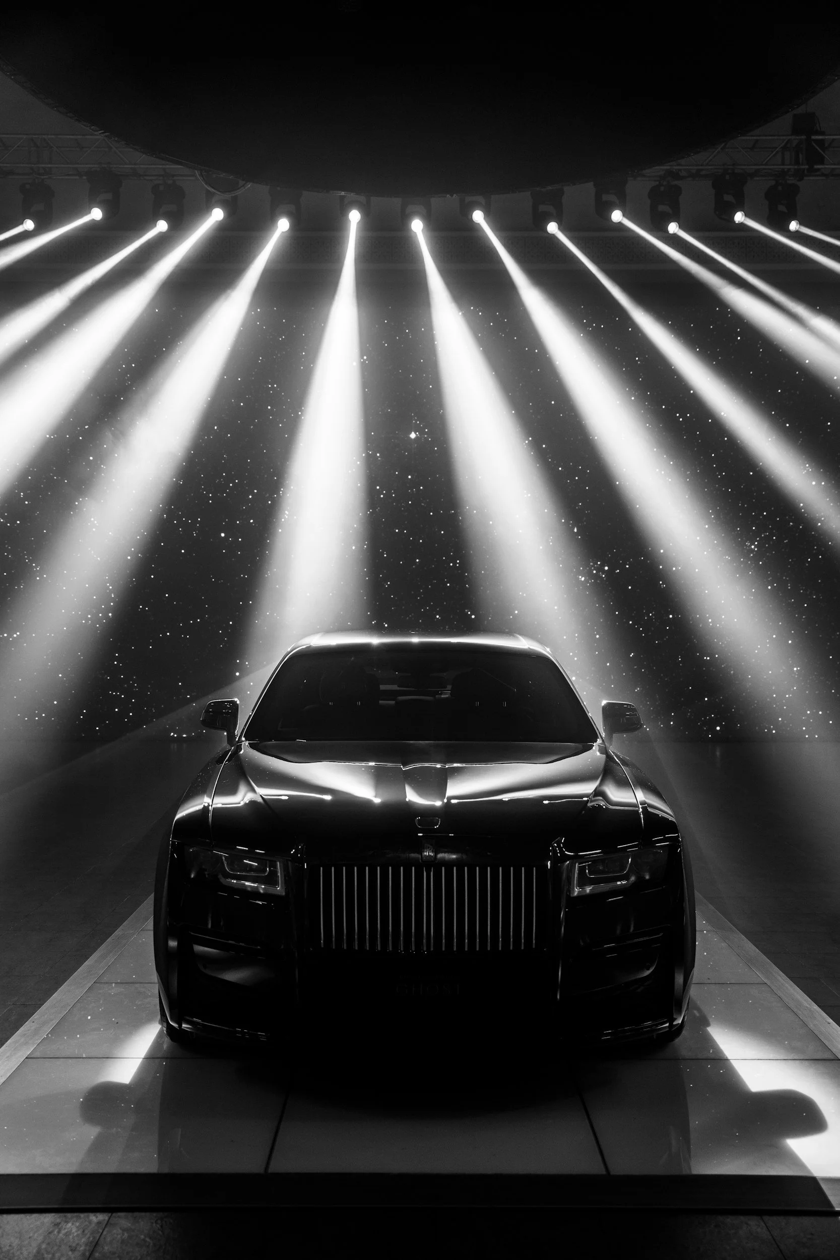 black car with 12 lights shining down on it with black background for picture
