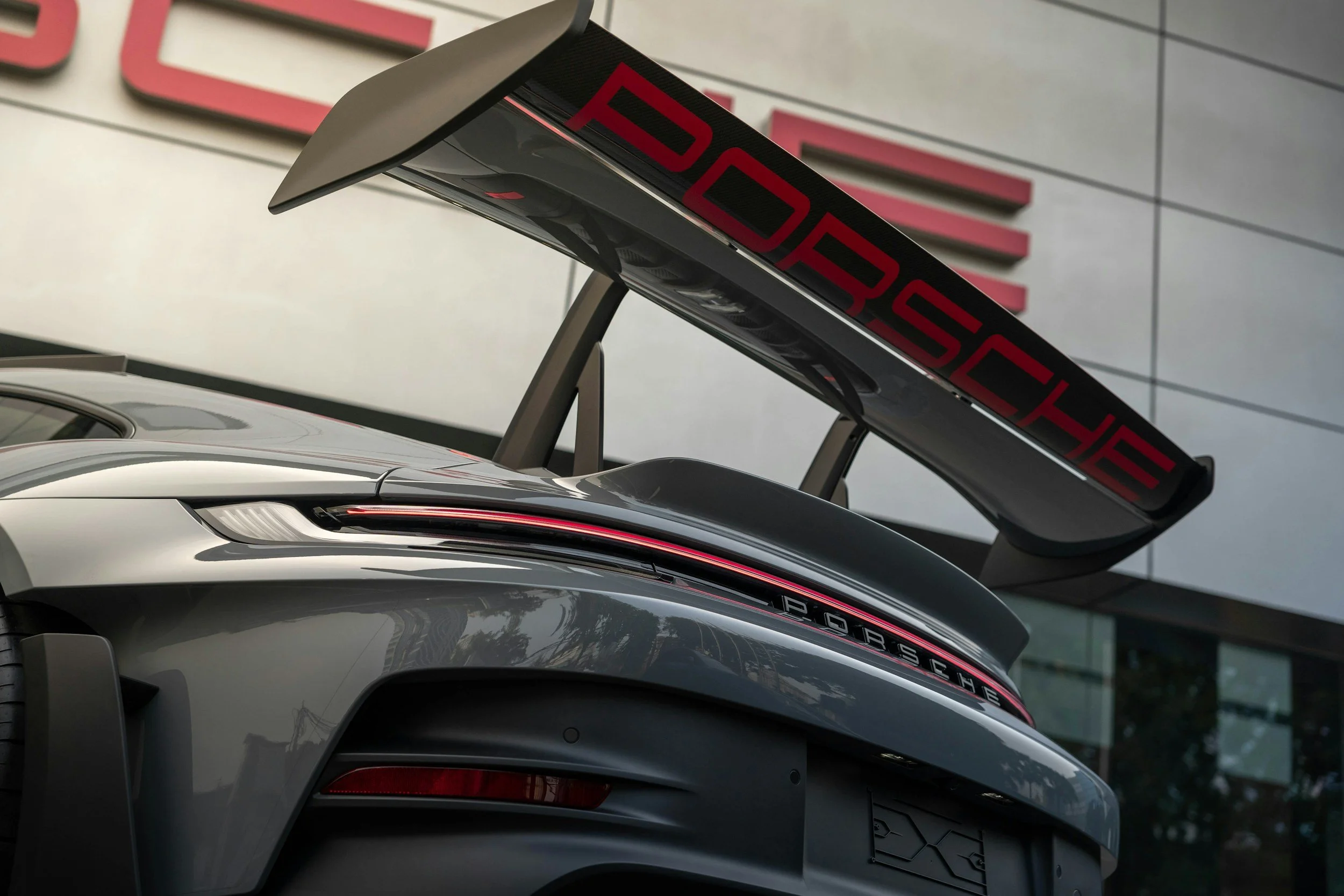 rear of a car showing large spoiler on back and name of car on it
