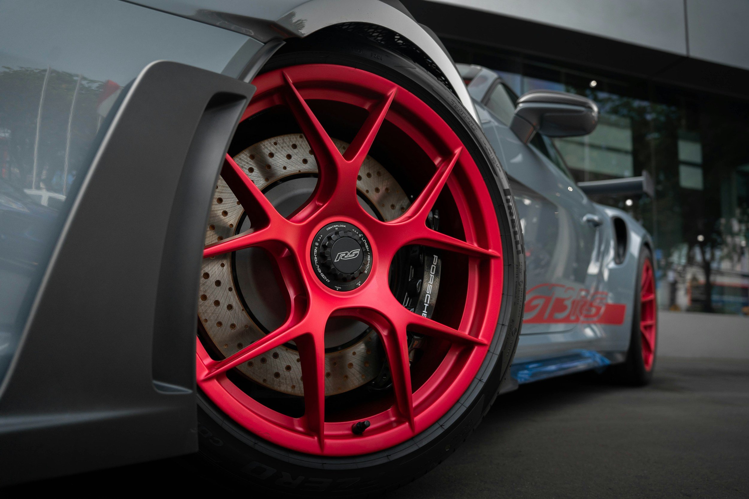 silver gray 2 door sportscar with pink custom wheels