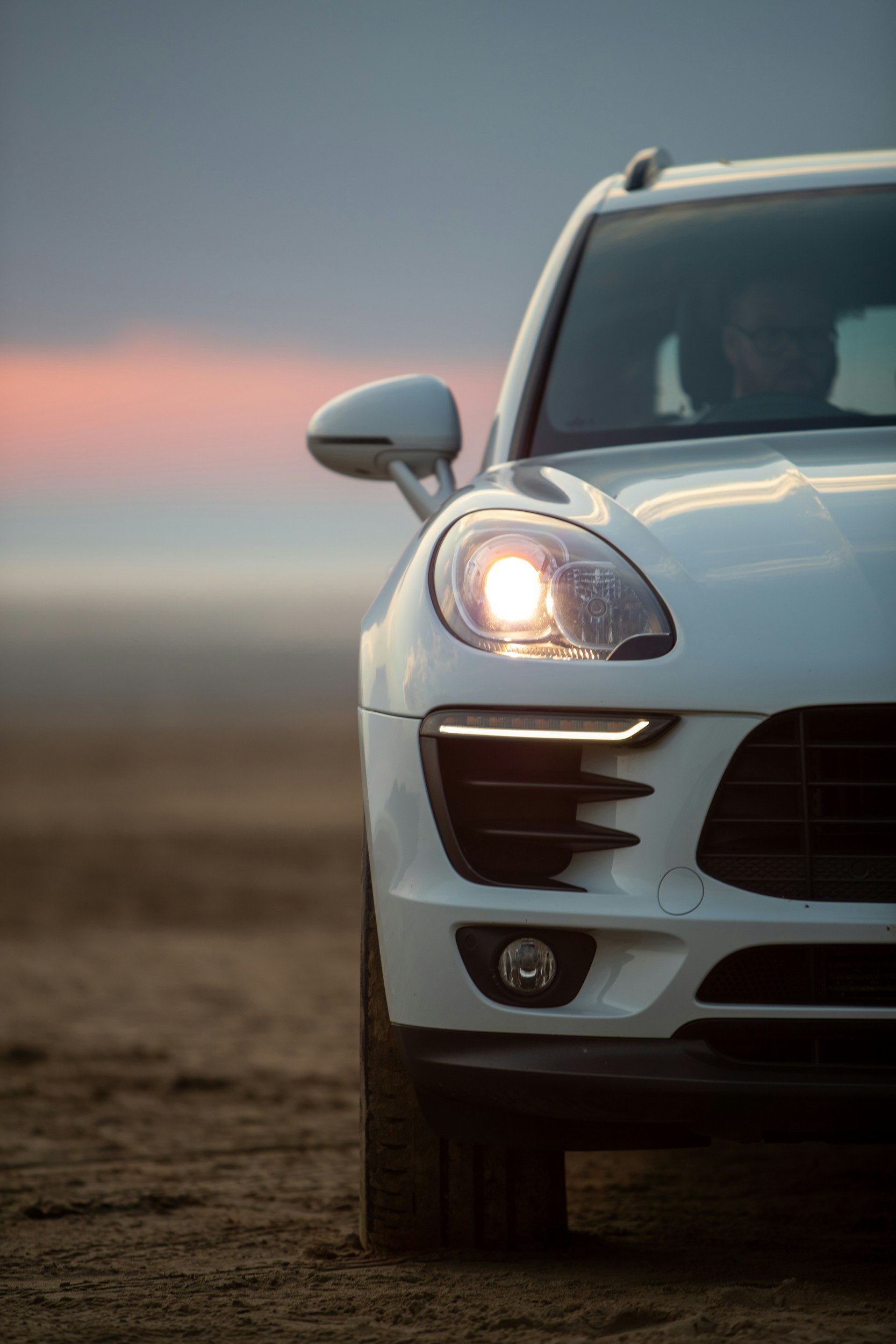 with high performance SUV driving down the road only showing the passenger side of the car