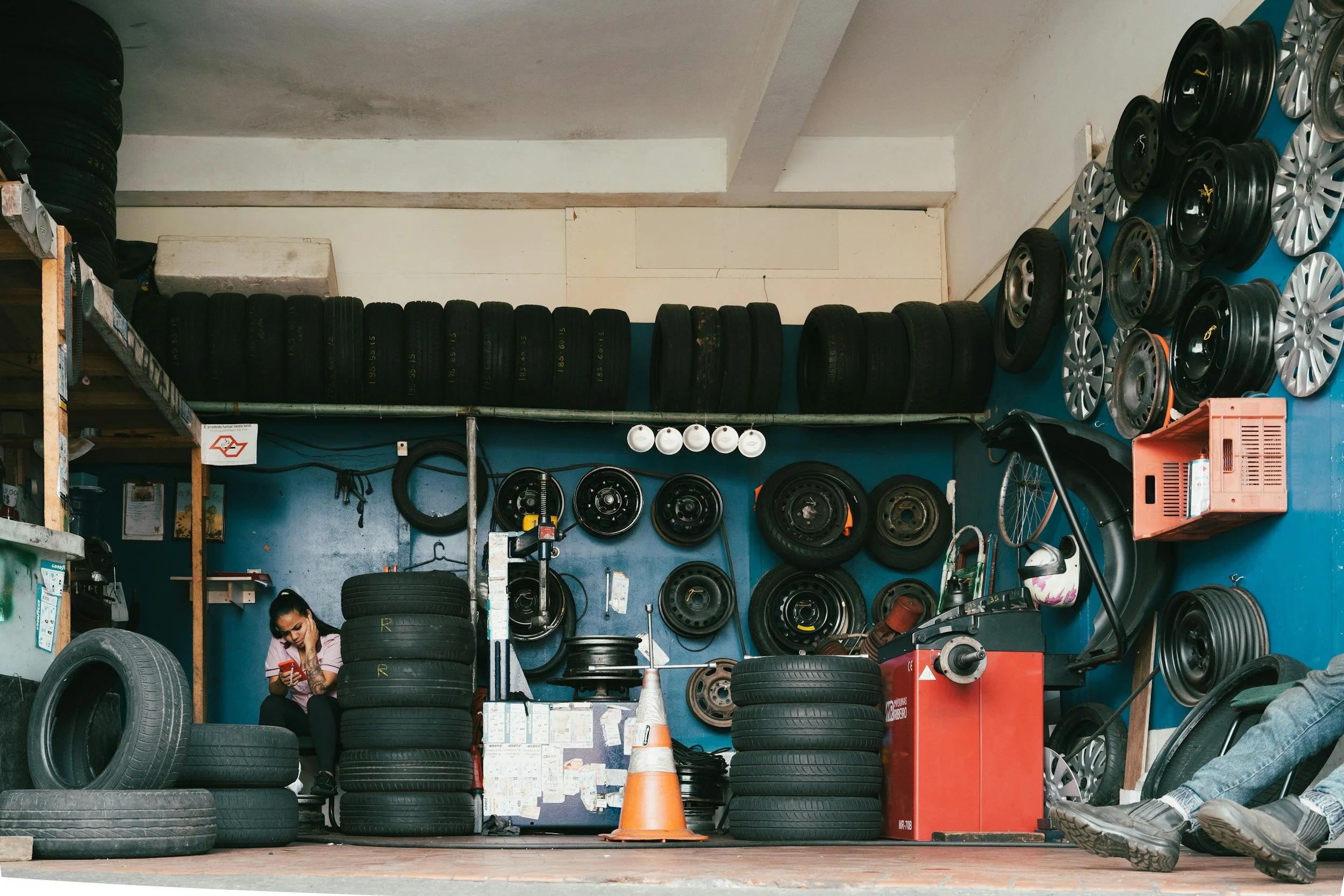 tire mechanic shop with lots of tires and tool box