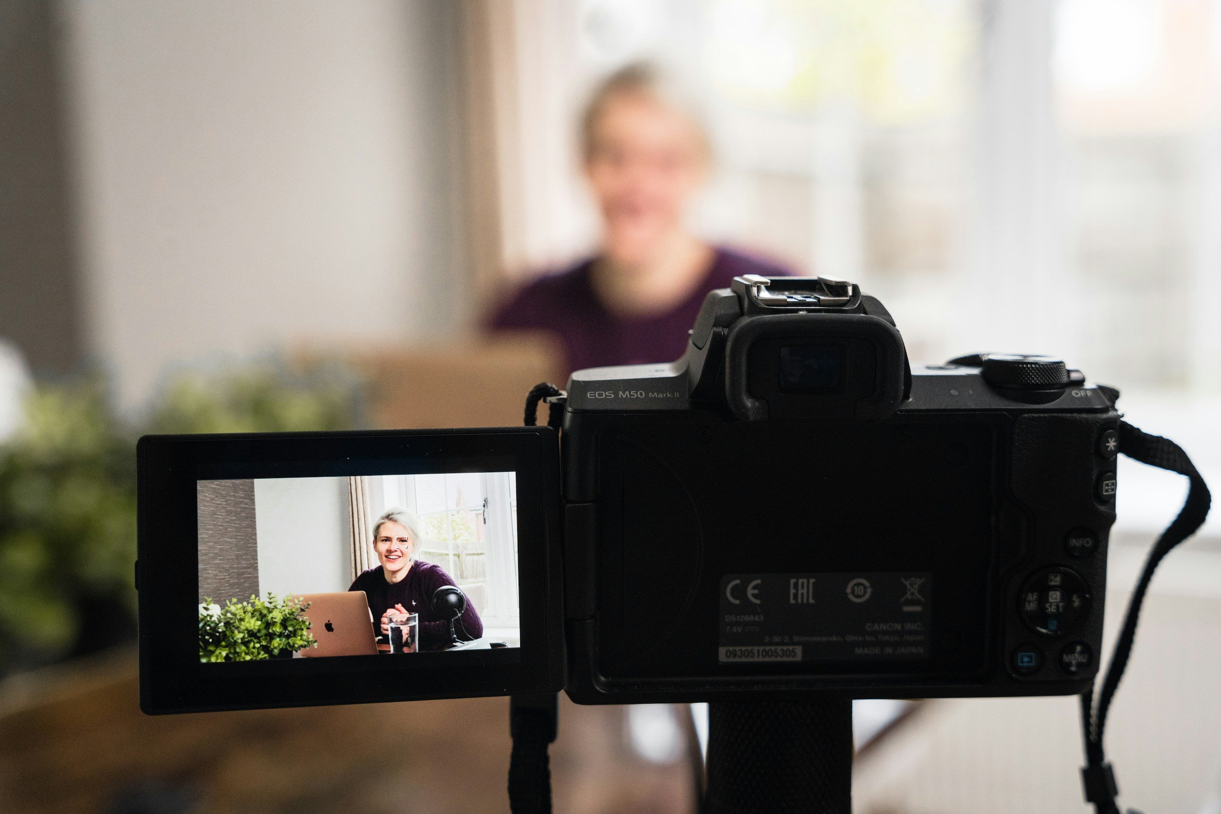 camera filming person with purple top interview
