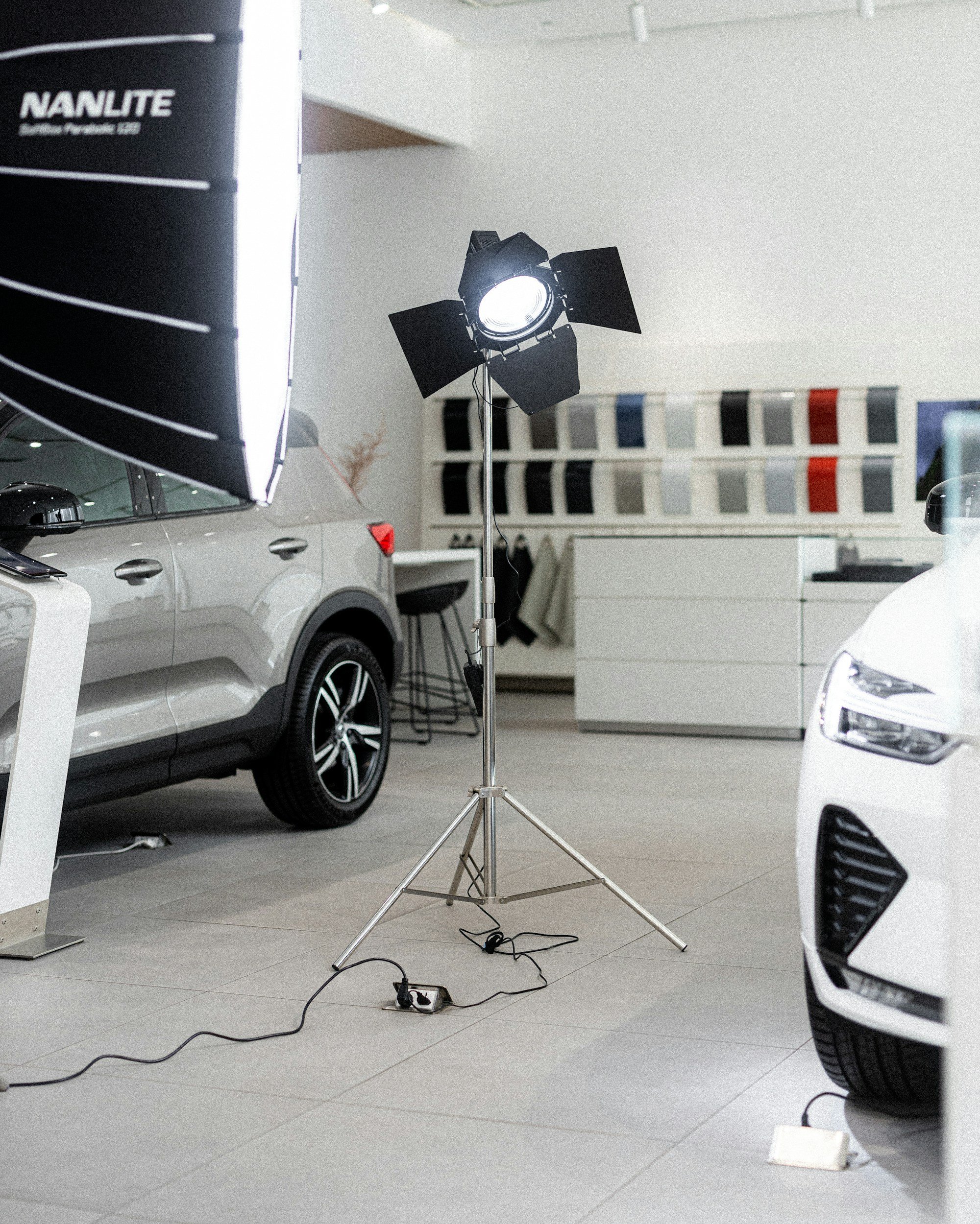 2 cars spotlight filming car shop