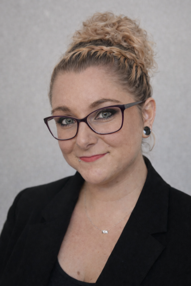 picture of blonde haired woman with black dress and glasses