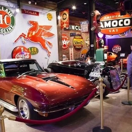 red corvette black hot rod neon lights with signs from yesteryear and in a car museum with pnw car smart