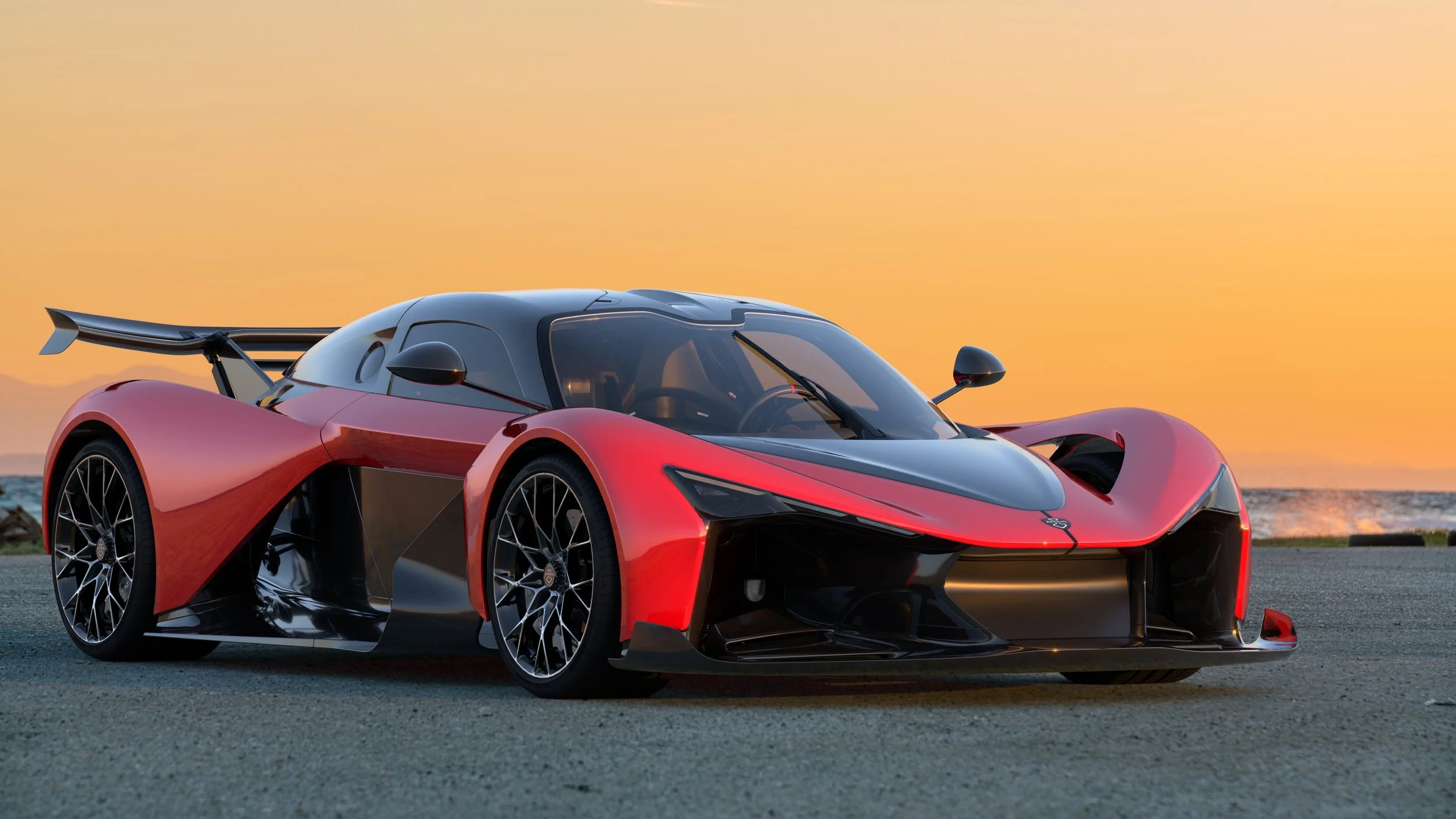 red and black sports car rear wing on cement yellow wall behind car