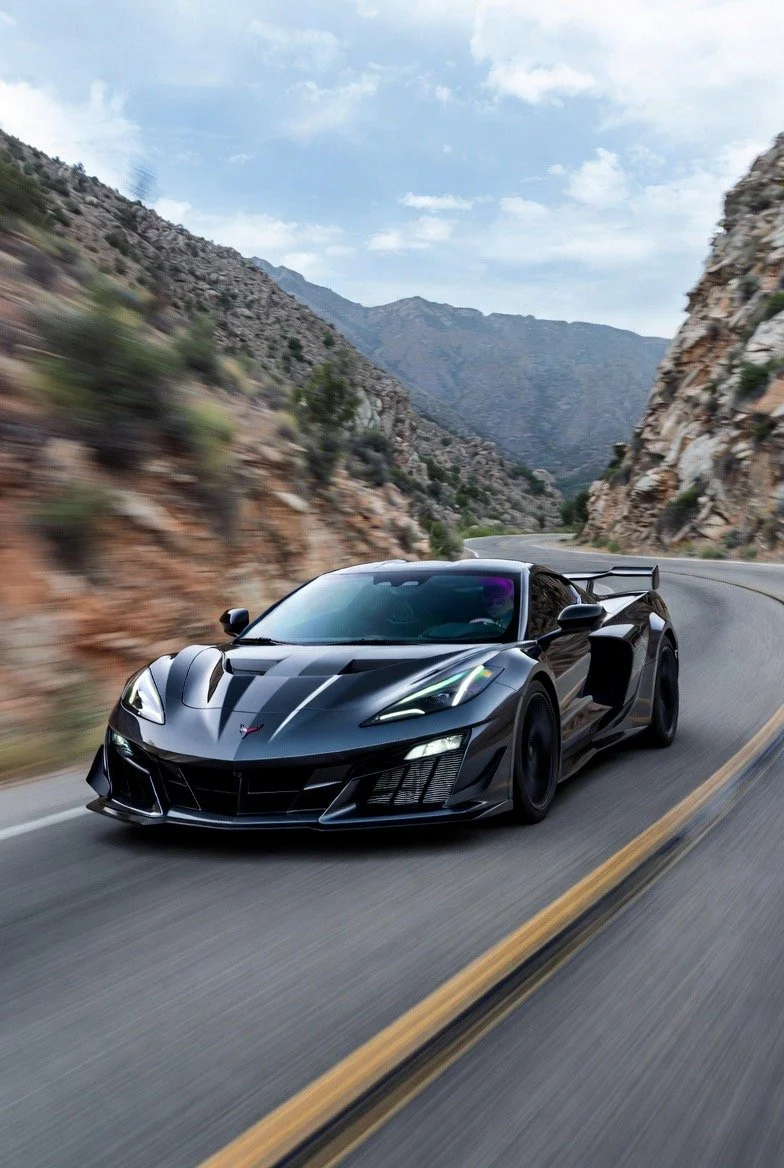 black sports car driving in mountain road
