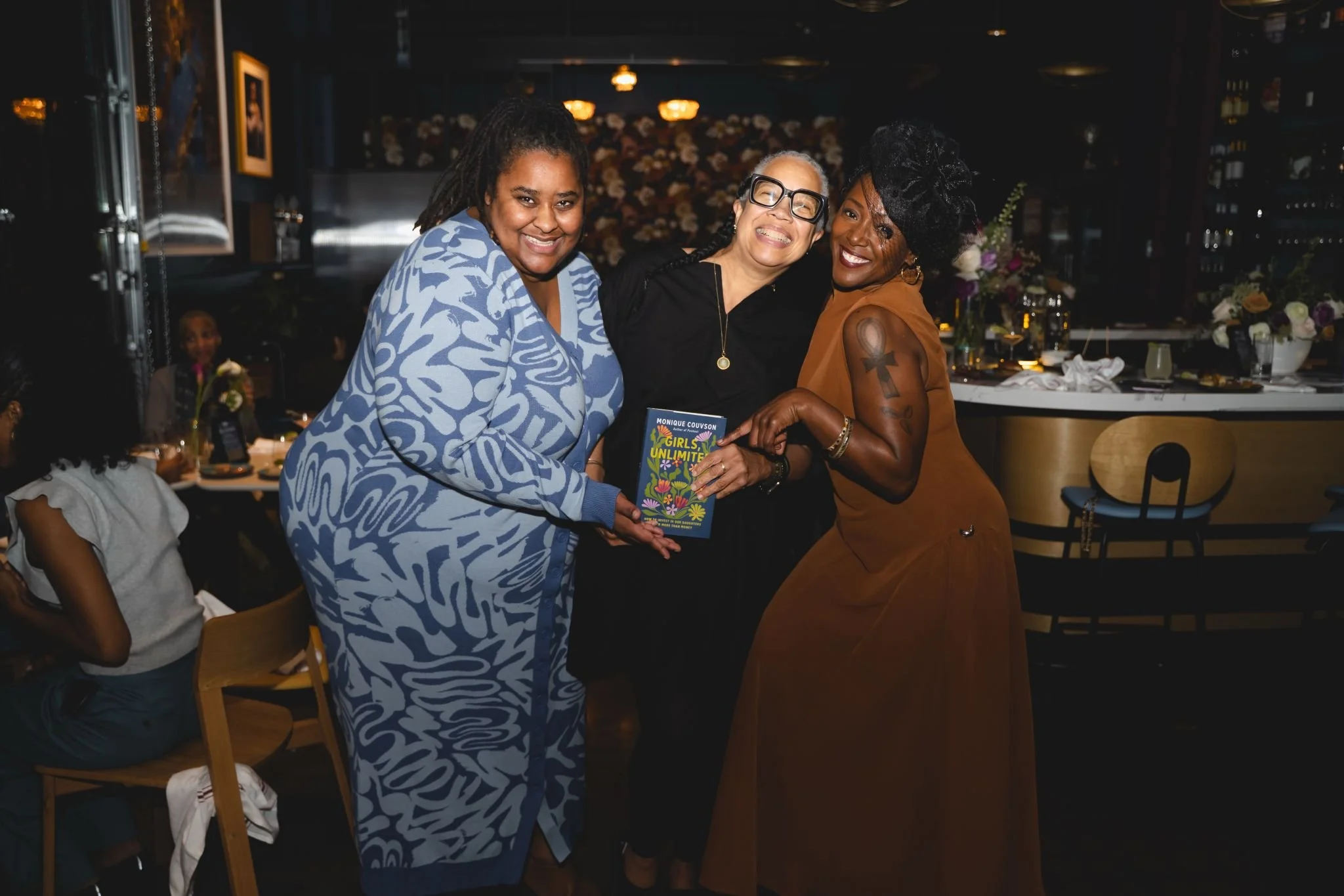 Three Black women looking at the camera smiling
