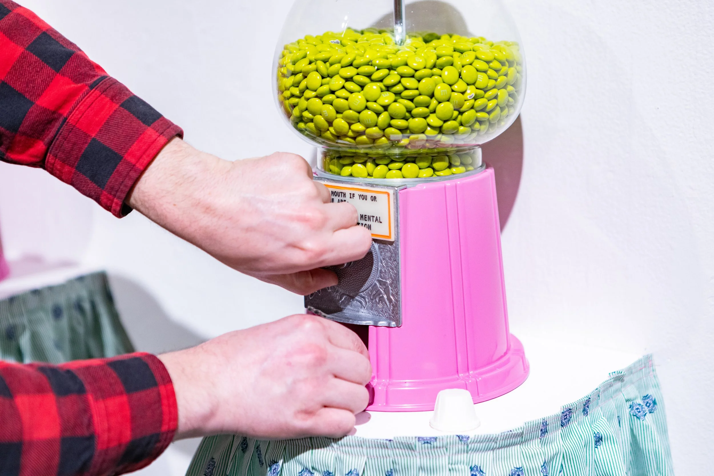 Take Two Be Seen
Patron turning machine crank for M&Ms