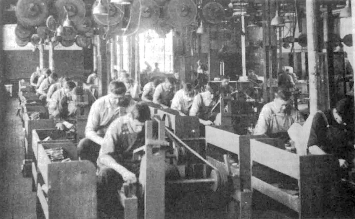 An early twentieth century photo of a grinding room in a knife factory most likely located on the Naugatuck River or one of the streams that feed into it.
