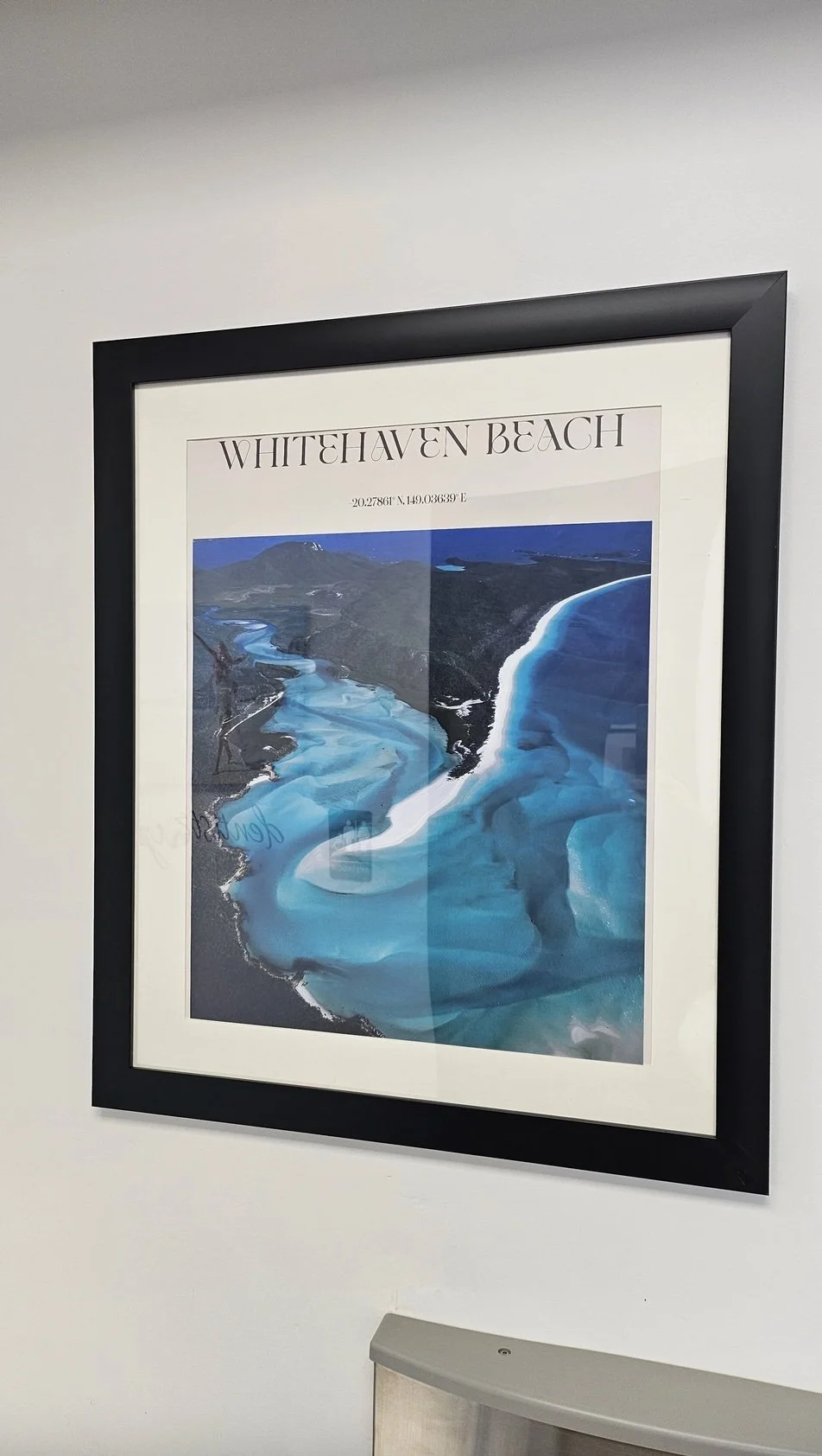 Framed poster of Whitehaven Beach with aerial view of the beach, turquoise waters, and surrounding land.