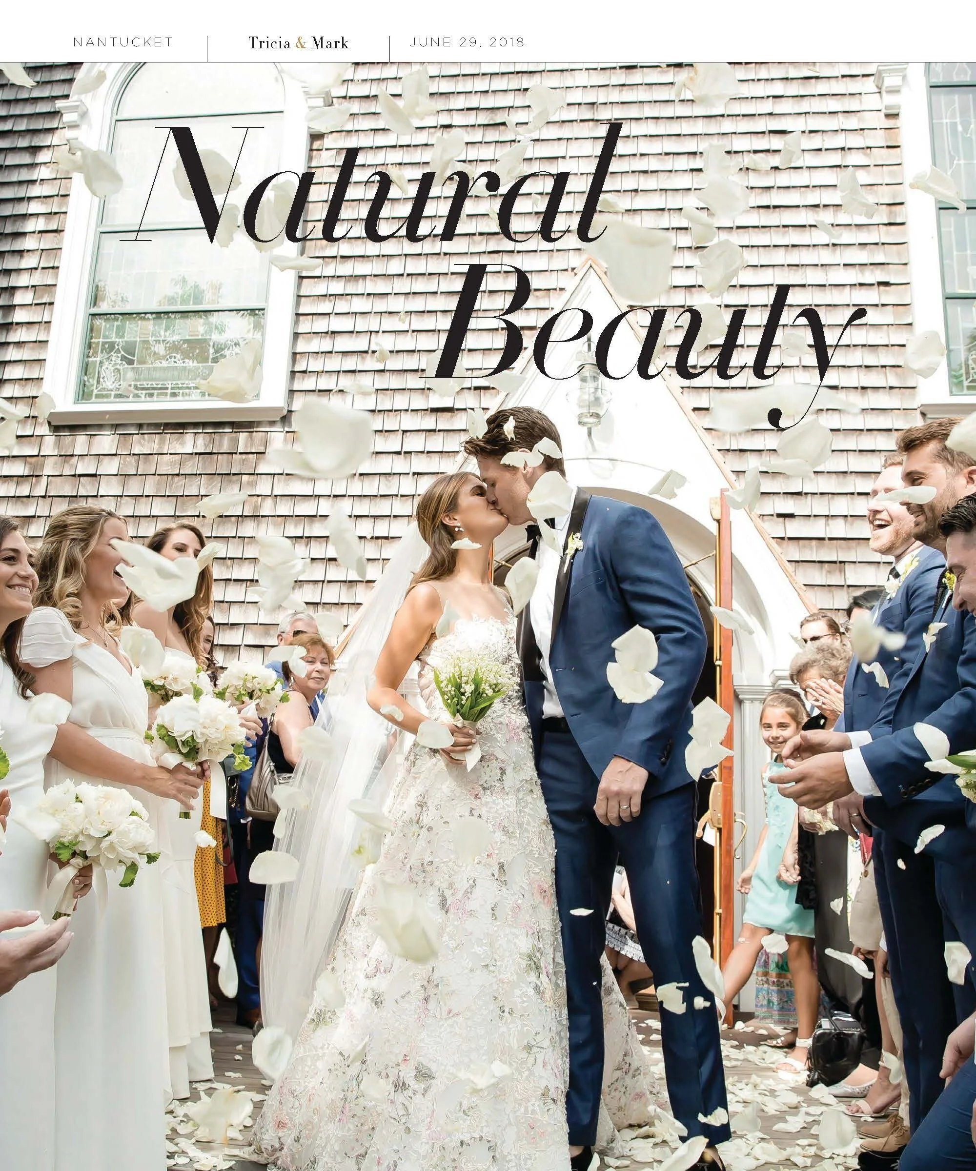 A wedding scene with a bride and groom kissing as flower petals fall, surrounded by bridesmaids and groomsmen outside a building with a shingled roof and large windows, with the text 'Natural Beauty' and wedding details at the top.