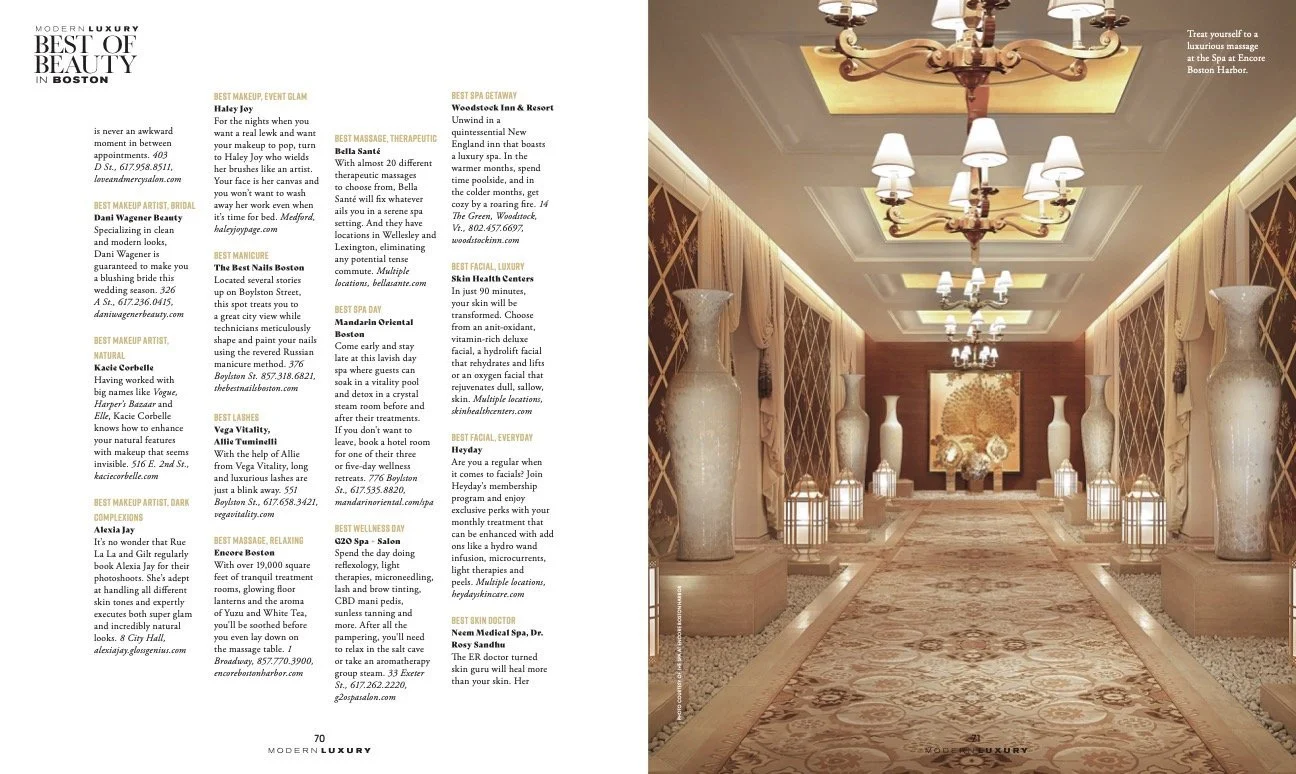 Elegant hotel hallway with ornate carpet, tall decorative vases, chandeliers on a tray ceiling, and soft lighting.