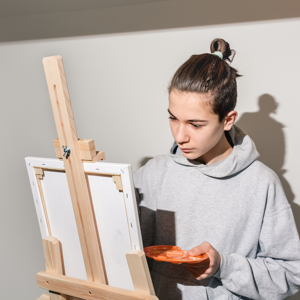 Teen painting on canvas