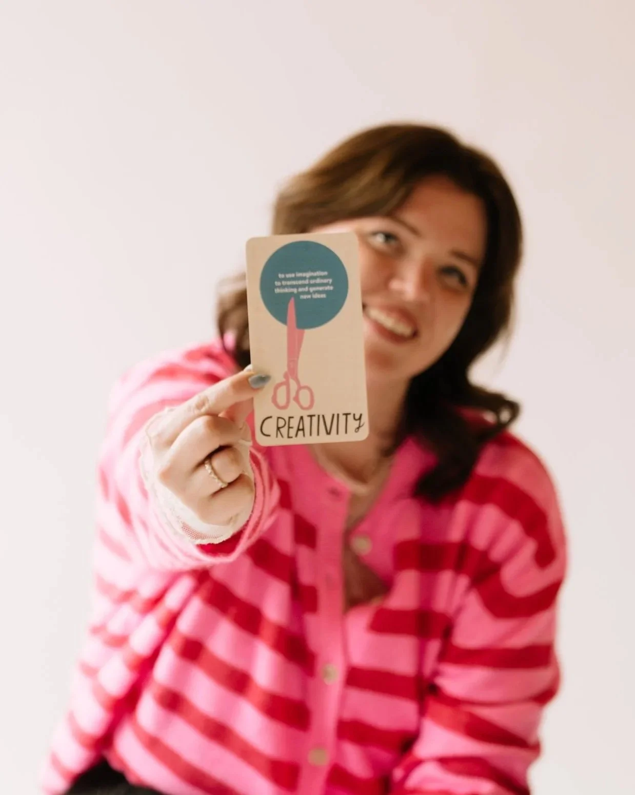 Person holding up a graphic about creativity
