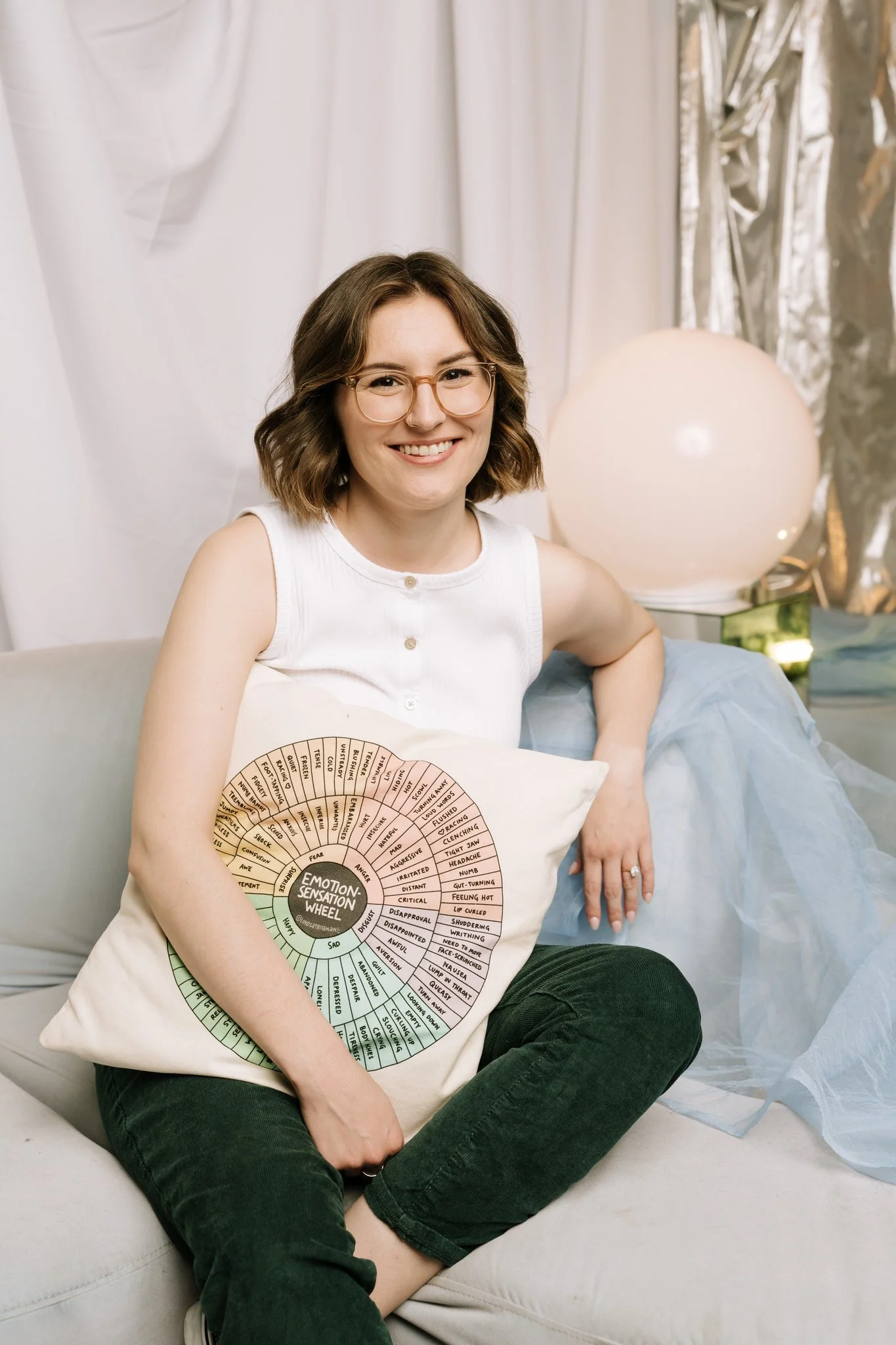 Person sitting on a couch in therapy holding a pillow 