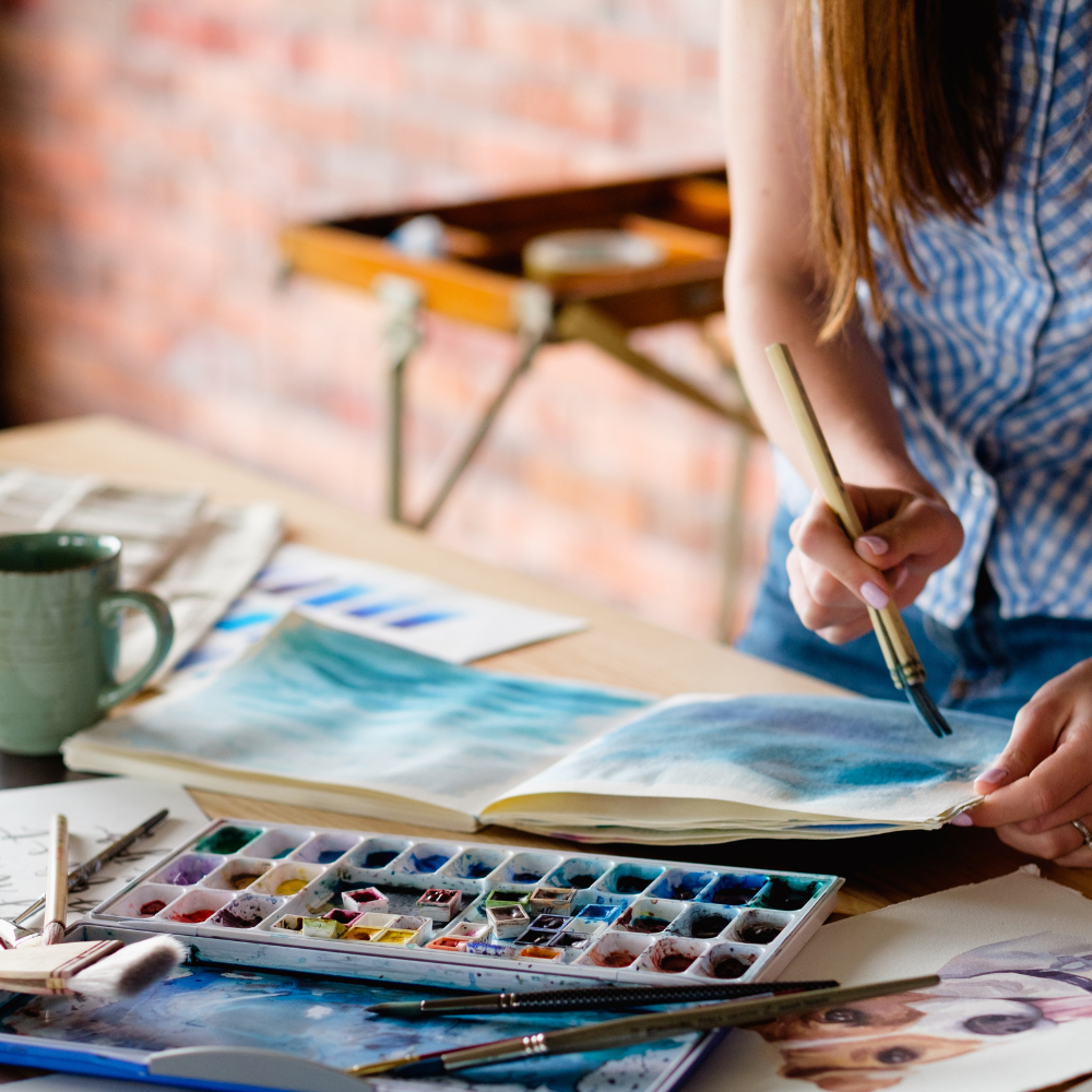 woman painting with water colors