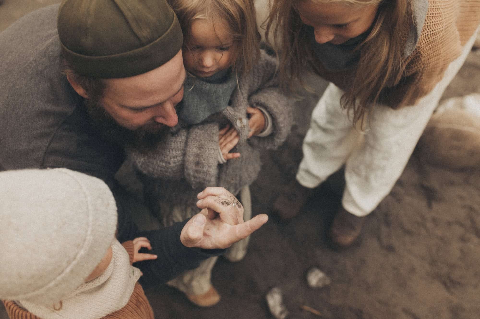 Father exploring nature with daughters