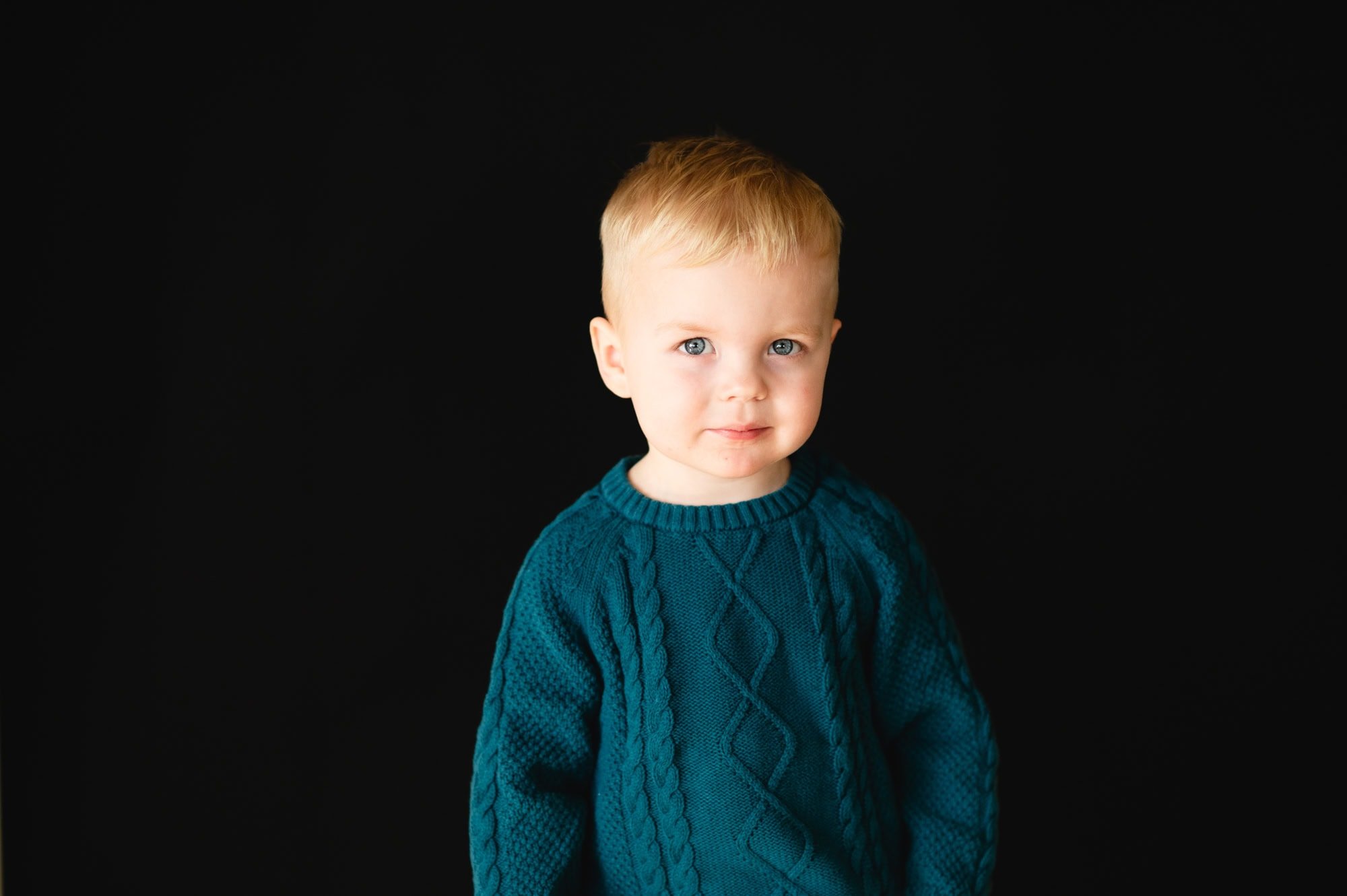 Smiling toddler captured in natural light at a Kita in Zürich by an authentic kids photographer.
