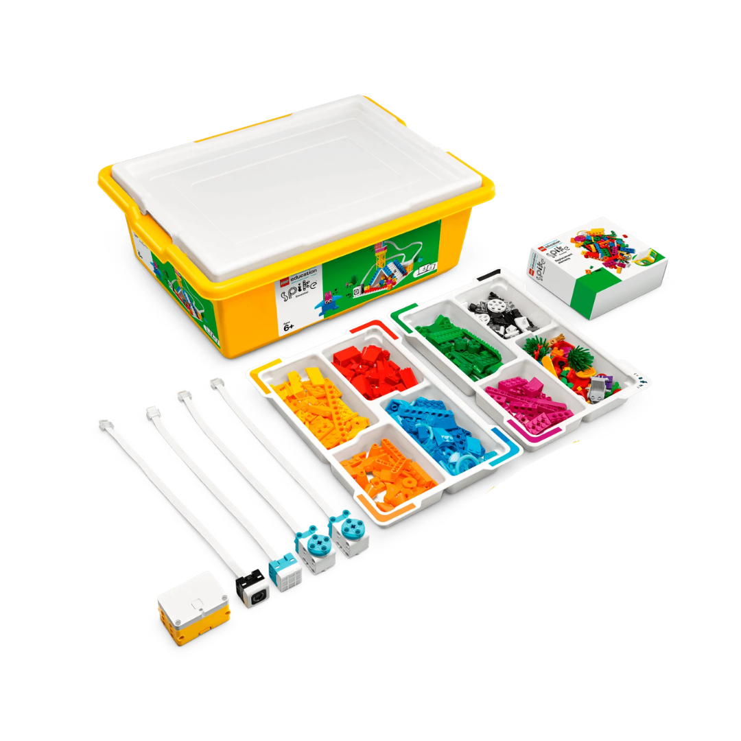 A yellow plastic storage box with a white lid, containing colorful Lego building pieces organized in a compartment tray. Includes a smaller box of Lego pieces, a connector, and three white rods with blue connectors.