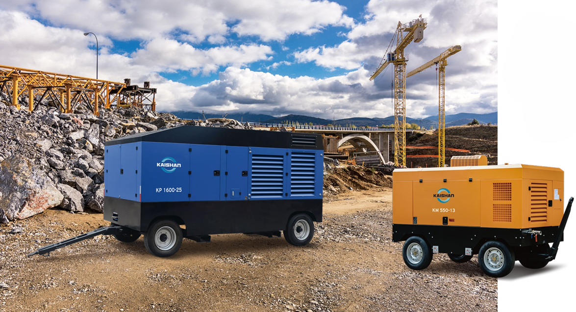 Kaishan KP 1600-25 blue and KM 550-13 orange towable air compressors at a construction site with cranes and a bridge