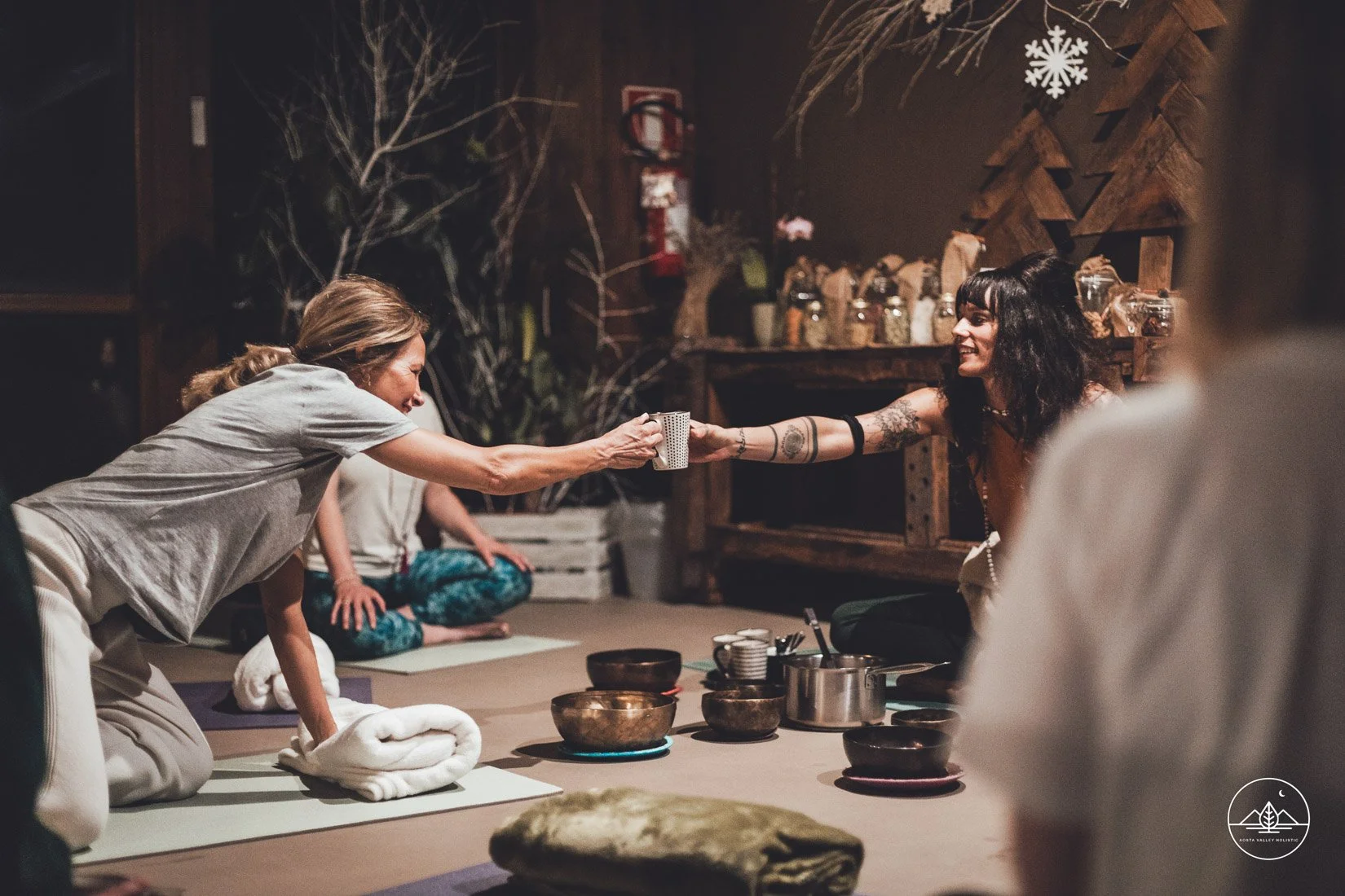 Our luxury yoga reterat Italy - cocoa ceremony, 1 woman gives the cup to another