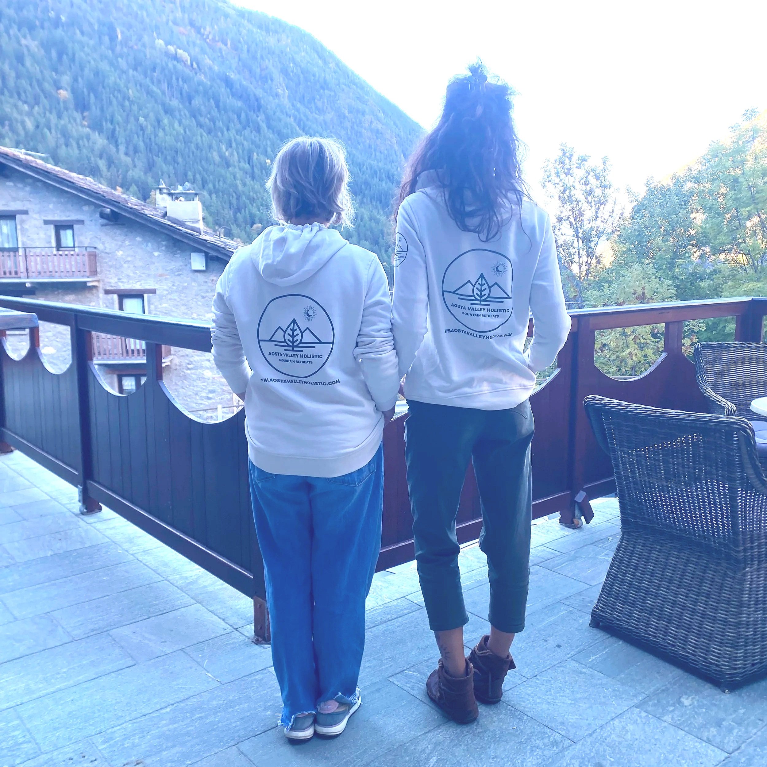 yoga in Italy - 2 ladies facing the mountain wearing the cream hoody