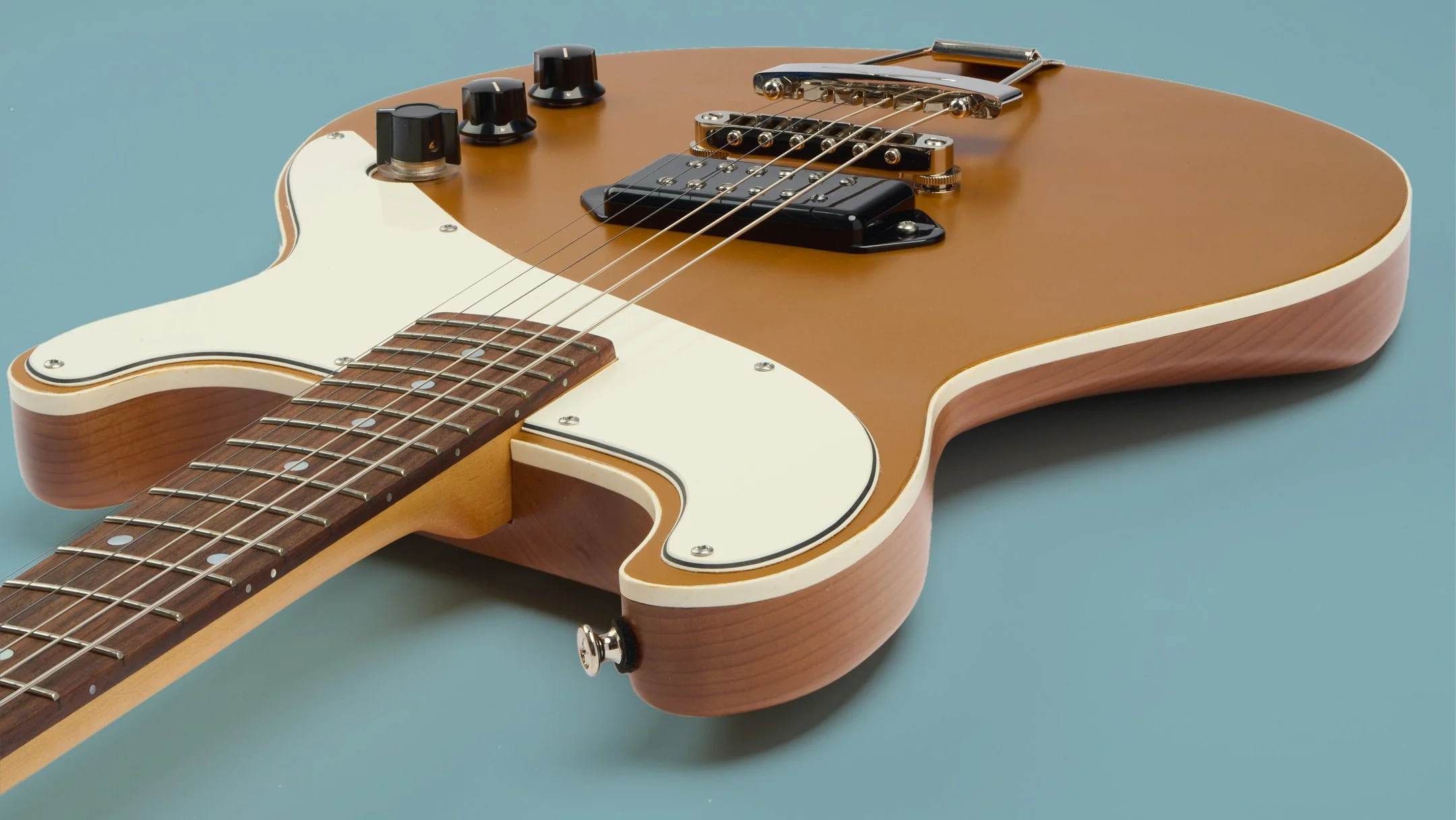 Handcrafted Samsa-J Goldtop Guitar with blue background