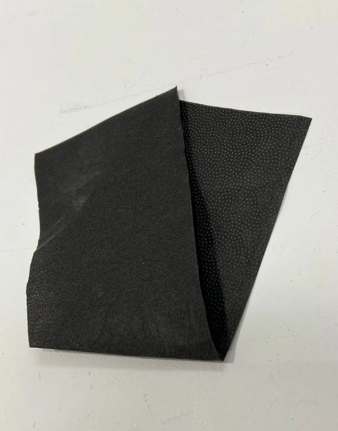 Discarded black interfacing fabric