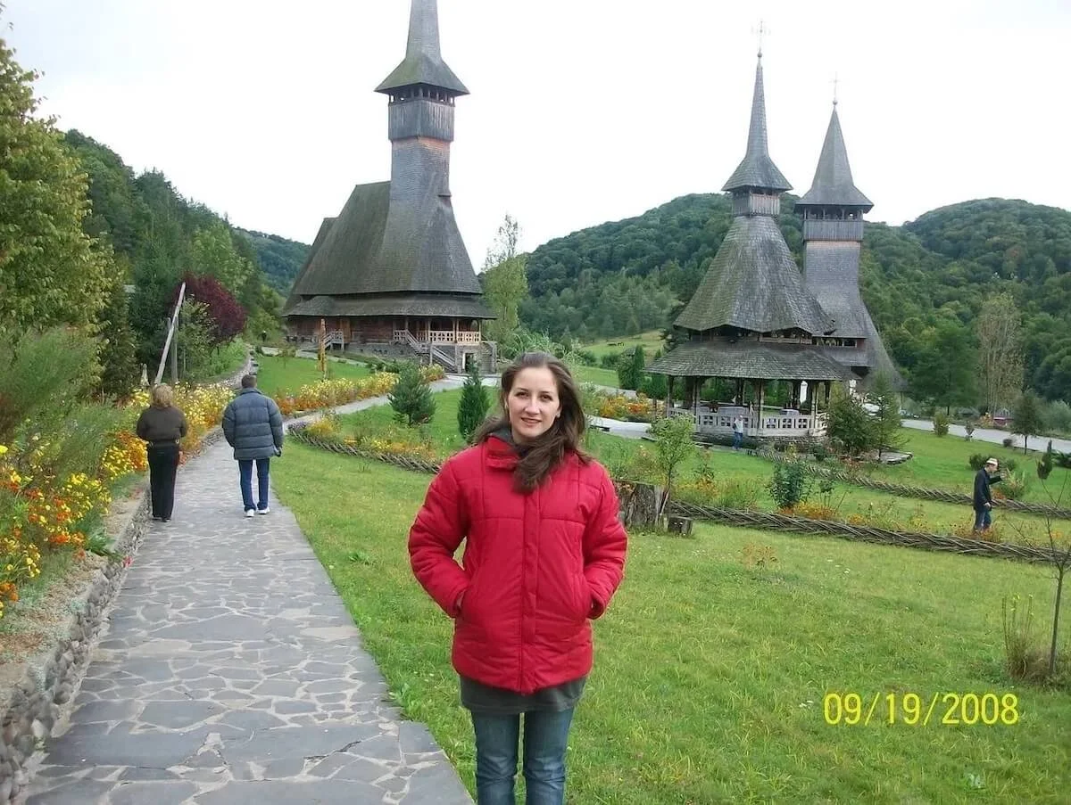 Eliza standing outside wearing a red coat, Maramures Romania 2008