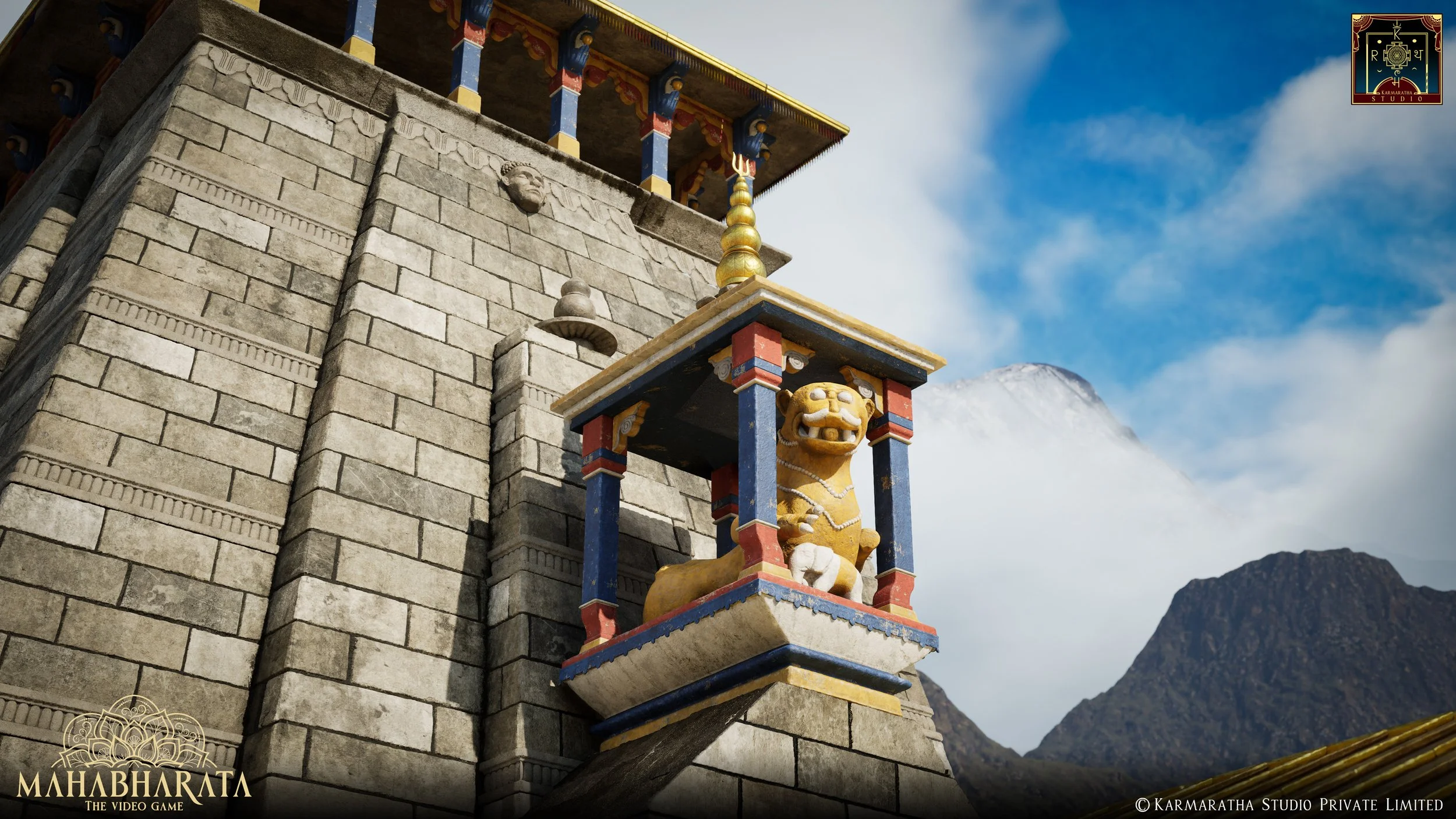 Close-up of a stone wall with colorful tiered architecture and golden ornaments, featuring a sculpture of a lion figure with a fierce face, painted in gold and white, set against a mountainscape with snow-capped peaks and a partly cloudy sky.