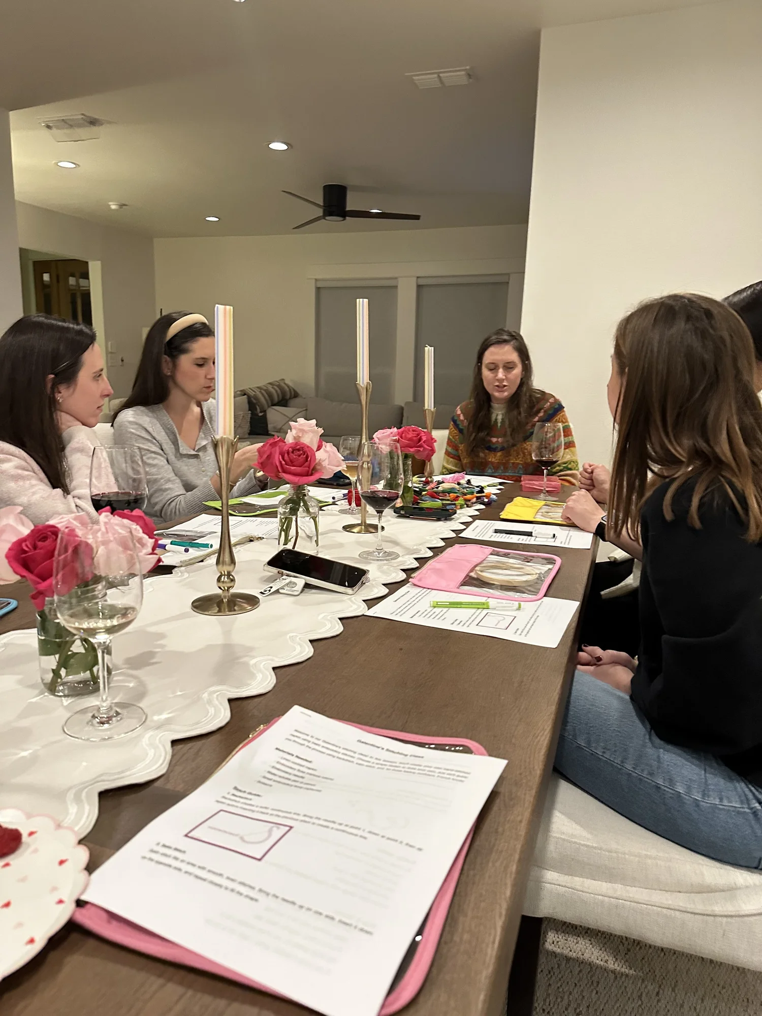 Guests gathered around a table for a guided stitching class