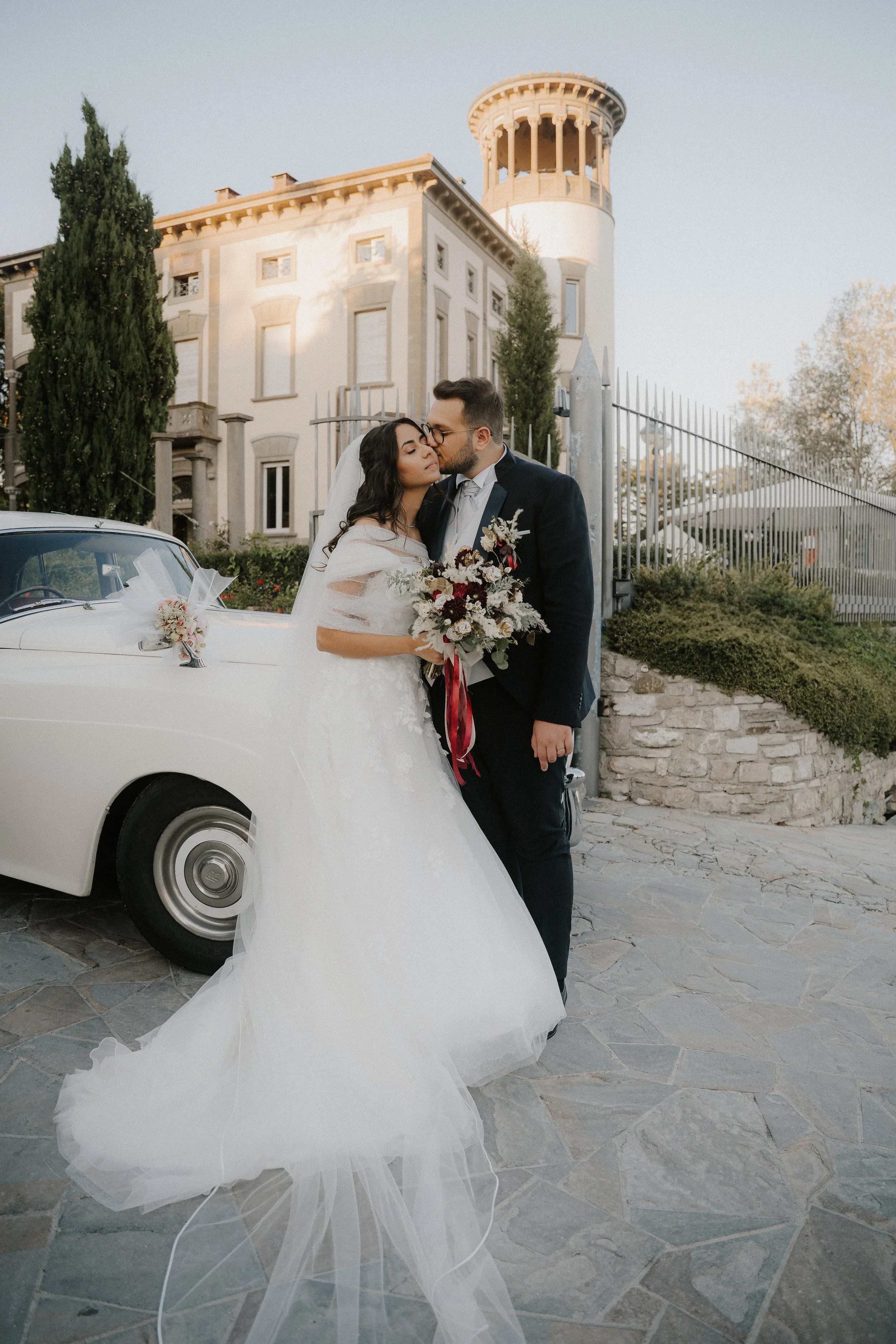 bride and groom standing in front of venue
