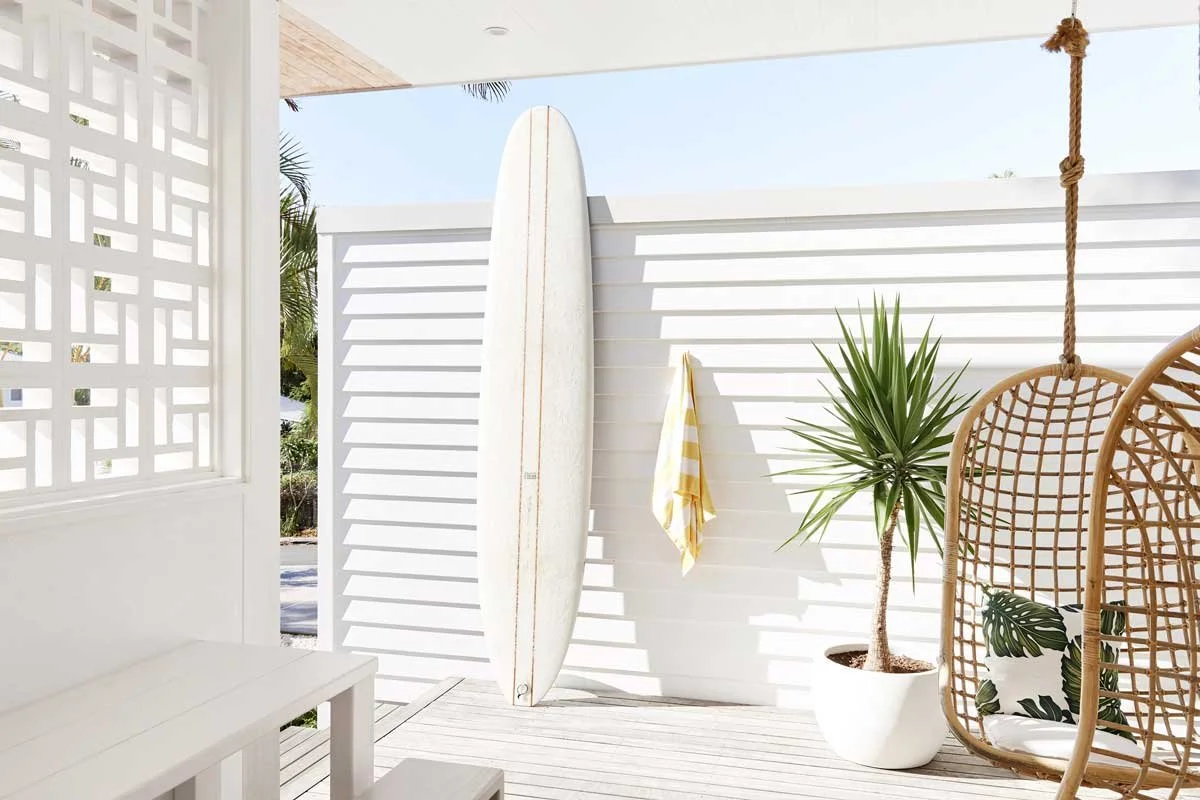 Bask-and-Stow-Byron-Bay-luxury-accommodation-Sun-Suite-room-balcony-swing-chairs-surfboard.jpg