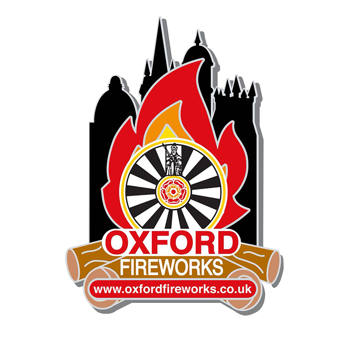 Oxford Fireworks logo featuring a stylised bonfire flame in front of the Oxford skyline, with a historic cartwheel at the centre incorporating the Oxfordshire rose. The design includes stacked logs beneath the bold "Oxford Fireworks" text and the web