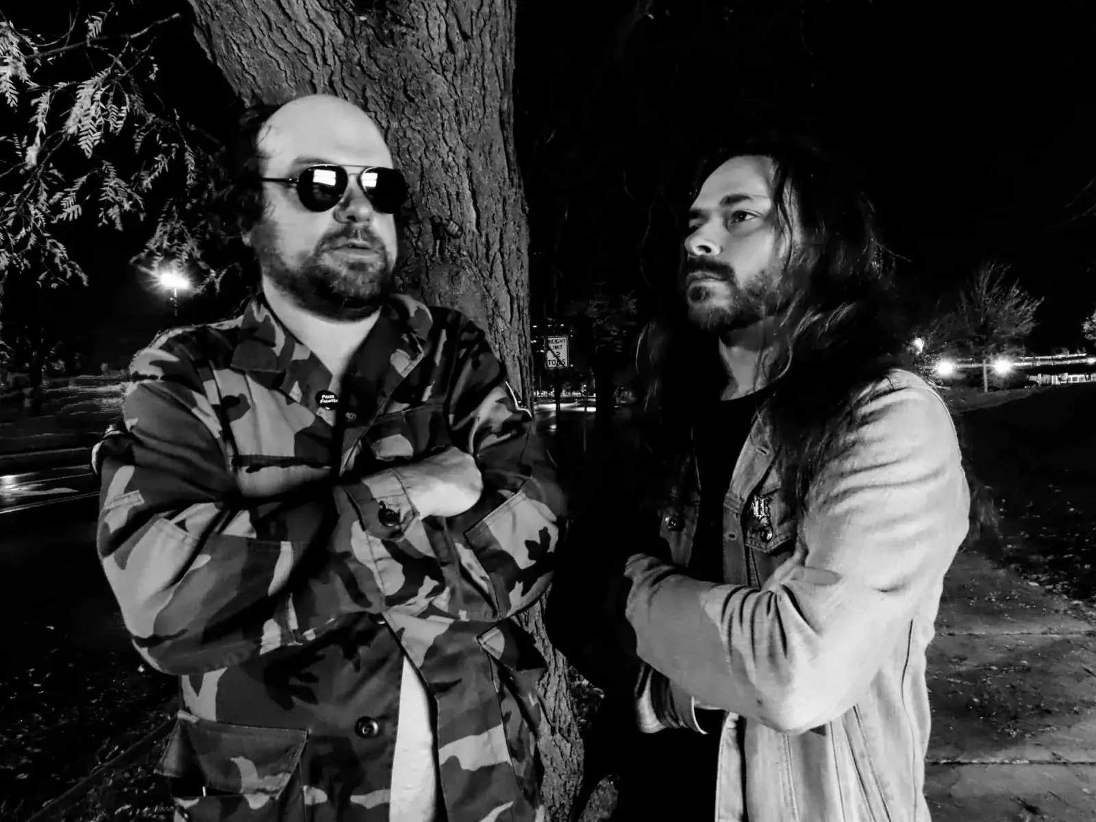 Members of Amputee standing outdoors at night, capturing the raw doom and black metal tension that shaped the band’s role in the Worship Pain lineage.