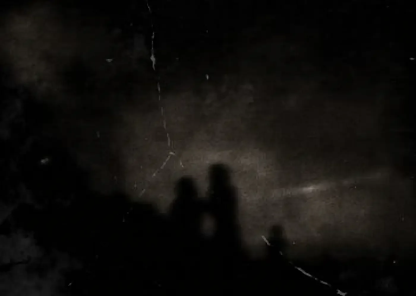 Shadowed figures from Funeral Sutra creating a restrained, cold atmosphere during an early performance.