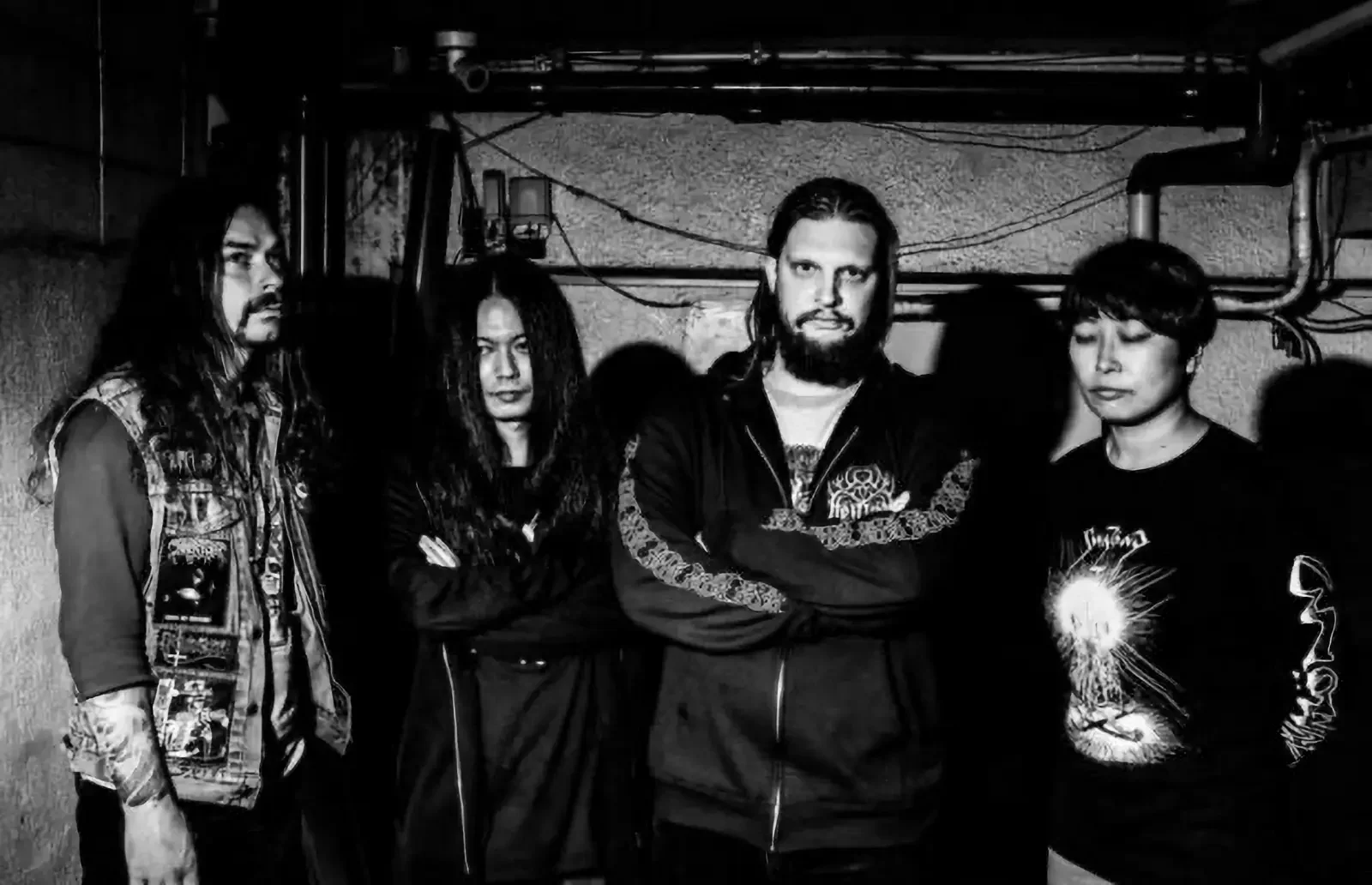 Swazönd band members photographed in a raw underground setting, reflecting blackened crust urgency and physical presence.