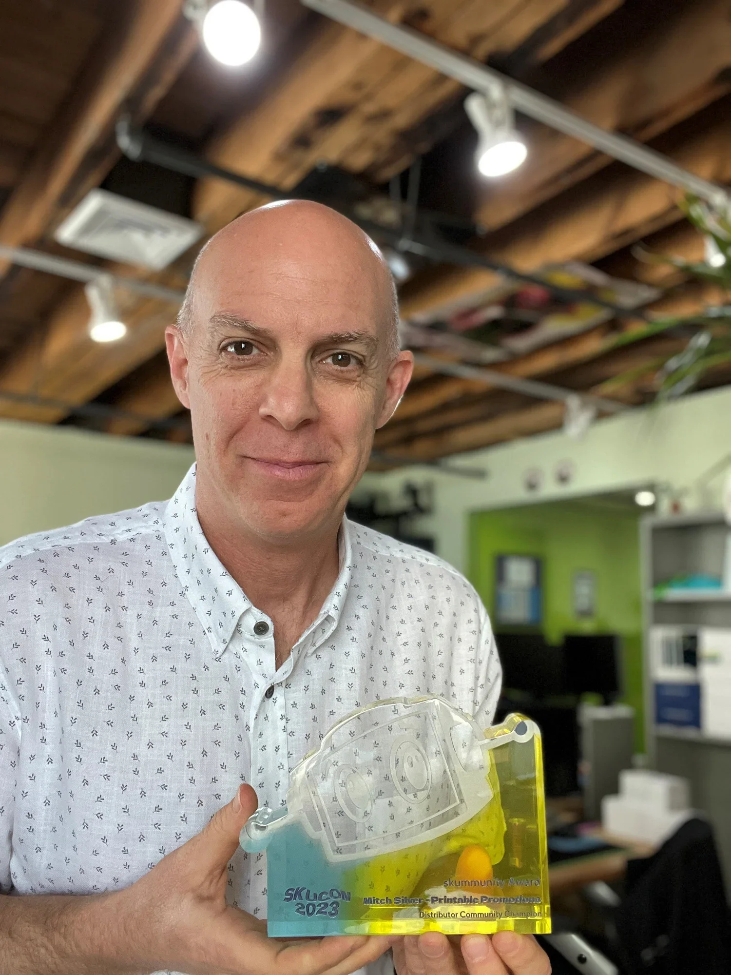 Image of a clear, engraved award from Commonsku, celebrating the Distributor Community Champion honor that required a replacement after the original went missing.