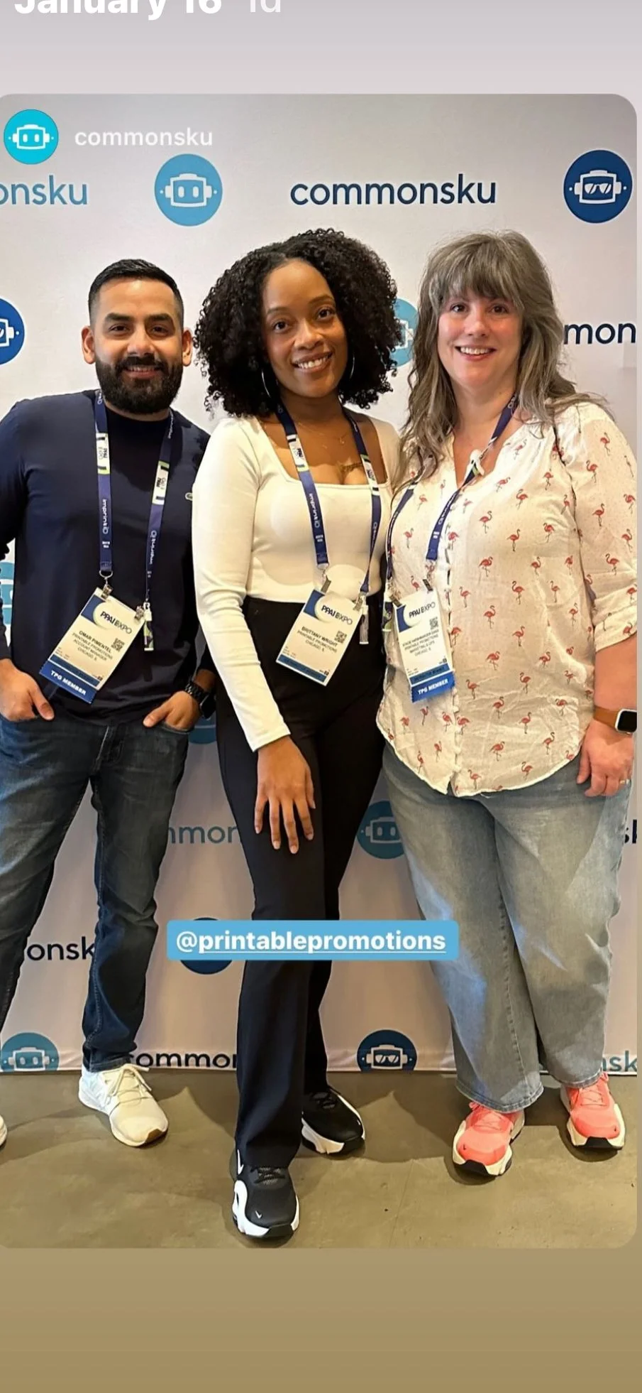 Three people standing in front of a backdrop with 'commonsku' logos, wearing conference badges, smiling for the photo.