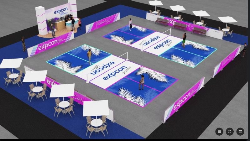 Indoor sports exhibition with expcon branding, featuring three pickleball courts with vibrant purple and blue designs and palm leaf graphics. Surrounding areas include seating with tables under umbrellas and various booth displays.