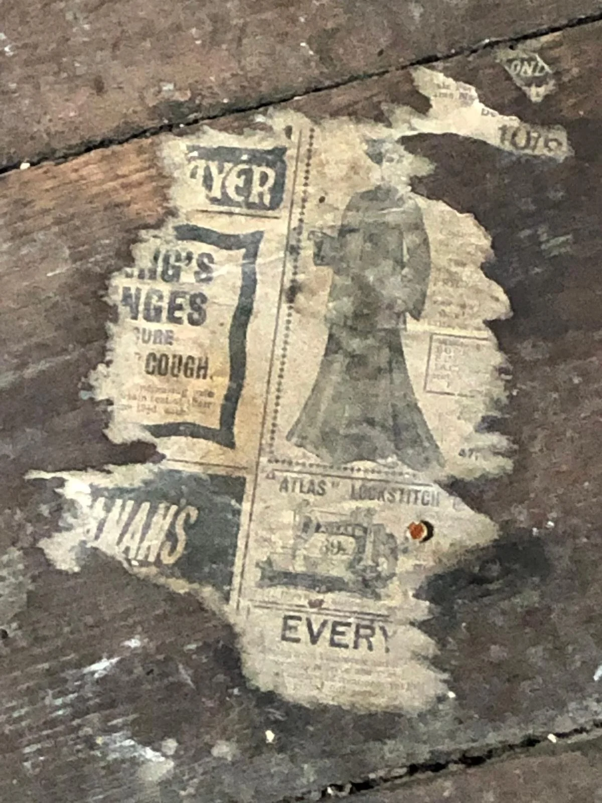 Old torn advertising paper on wooden floor with images and text promoting sore throat relief and referencing Atlas Looshitch.