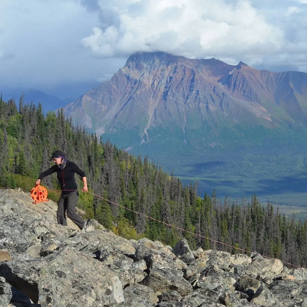 Cassie Stuurman, geophysics MSc. student at UT Austin, lays out a square of wire on the ground with which we produce a transient magnetic field to probe the depths of Sourdough Rock Glacier.