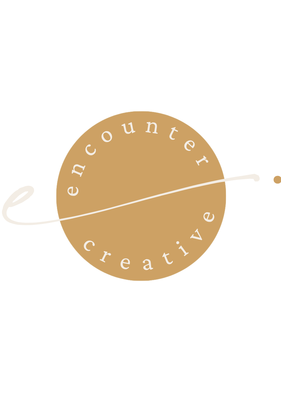 Logo with the words "encounter creative" arranged in a circle around a gold-colored circle, with a white curved line crossing through the circle.